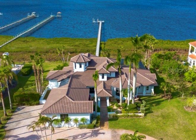 This incredible waterfront home sustained no flood damage during recent storms, providing much peace of mind. Discover unparalleled luxury and waterfront living at Cypress Creek. This spectacular property is a boater’s paradise, nestled on the Manatee River with 180° of unobstructed water views. The new dock and 10,000-lb boat lift are your gateway to adventure, just steps from your backdoor, with ample space for your vessel. This expansive 4,802 sq. ft. home is a haven for water enthusiasts, offering direct access to the Gulf of Mexico and nearby award-winning beaches. Completely renovated, including a new roof and 3 A/C units, this better-than-new home is a masterpiece of luxurious design and premium finishes. Offering a lifestyle of comfort and refinement with no high HOA or CDD fees. Situated on a sprawling one-acre lot with a serene pond view out the front, this property provides the ultimate in privacy and picturesque surroundings. The updated 5-bedroom, 5-bath home with two owners suites offers a main-level suite for optimal convenience and an upstairs suite to give separation for family and guests. Indulge in spa-like bathrooms featuring high-end fixtures, oversized walk-in showers, soaking tub, and dual vanities designed for ultimate relaxation and comfort. Both with breathtaking river views. Enjoy serene sunsets from the second-floor private deck, allowing for magnificent sightings of dolphins, manatees, and so much wildlife! This chef’s dream kitchen offers upgraded granite countertops, soft-close cabinets, new smart stainless steel appliances, and a walk-in pantry. With Smart Home Integration, enjoy the convenience of controlling A/Cs, lighting, pool settings, and more right from your phone. Step into your private resort backyard, featuring a lagoon-style saltwater pool with a travertine deck and spectacular waterfall. New lanai cage with no-see-um screen for the ultimate panoramic view! A bathroom with shower and enclosed sitting area elevates your outdoor living experience. The community is conveniently located near top golf courses, shopping, dining, airports, and more. Enjoy the freedom of boating from your backyard to local beaches, waterfront restaurants, and the Gulf. This rare find combines modern elegance, convenience, and an unmatched boater-friendly lifestyle. Schedule your private tour today and experience luxury waterfront living at its finest!