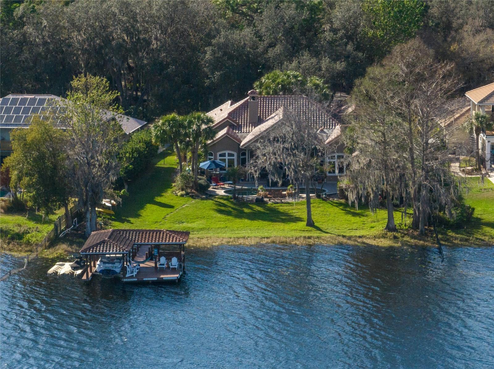 Price Improvement! Lakefront Retreat located on a lushly landscaped 1.38 acre lot, with 113 ft. of waterfront shoreline on Lake Brantley!!! You'll enter the property along a long winding driveway, canopied by large oak trees and mature landscaping. As you arrive at the house the driveway has a large circular turnaround, with a beautifully landscaped centerpiece Koi pond, with waterfall, and stepping stones. This expansive Mediterranean charmer will make you feel right at home. The floor plan is very compatible for a large family, or entertaining. Very spacious rooms throughout, exquisite wood and stone tile flooring. The kitchen will exceed expectations with huge center island, granite countertops, and custom cabinetry, overlooking the large dinette, lanai, pool, backyard and lake. The kitchen has its own wine cellar with a wrought iron gated entry, and additional serving area with office workstation. Family room boasts warm, rich, custom wood cabinetry with gas fireplace, and multiple sets of glass doors with a stunning view of the lake. The spacious and private owners retreat, with sitting area also offers a beautiful lake view. The master bath is approximately 500 s.f. with dual vanities, walk-in shower, separate oversized whirlpool jacuzzi tub, walk-in closet, as well as an extra flex space...perfect for home gym, lounge area, etc. Enjoy outdoor lakefront living insect-free, with the motorized retractable lanai screen. The L-shaped covered pool bar features a built-in grill, tile countertops, and just steps from the Tommy Bahama full cabana bath with AC. The low maintenance composite wood dock offers open and shaded lounge areas, as well as an electric boat lift. Call today for a private viewing!