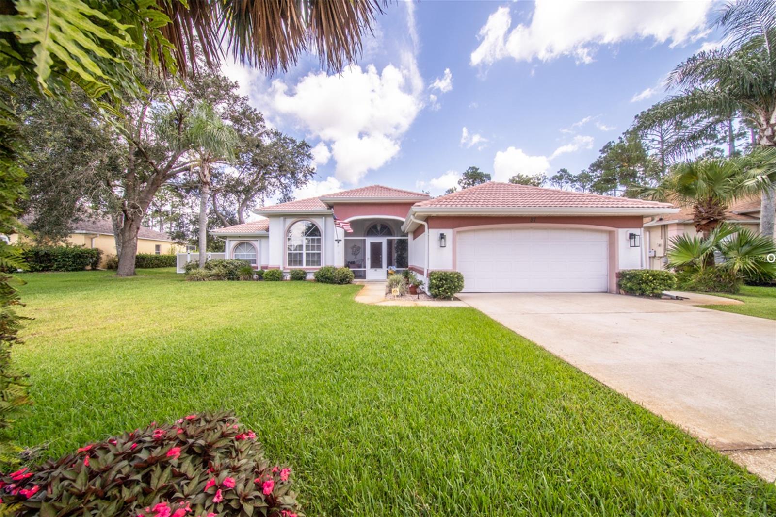 You will not find another property like this in Palm Coast! Welcome to this beautifully maintained 3-bedroom, 3-bathroom pool home nestled on over an acre of fully fenced property, offering privacy, space, and a wide range of valuable upgrades. Backing up to the Cypress Knoll Golf Course, the home provides tranquil views and no rear neighbors, creating a peaceful and private retreat. Inside, you'll find a spacious split-bedroom layout with a well-appointed kitchen featuring granite countertops. The home is equipped with a 3-ton, 16 SEER A/C system installed in May 2018, complete with a UV Active Ionic Air Purifier to ensure year-round comfort and enhanced indoor air quality. All three full bathrooms provide functionality and comfort, and a new hot water heater was installed in 2024. Step outside to enjoy a beautifully resurfaced pool (2017) with a Nano Saltwater System with a powerful 400,000 BTU pool/spa heater, perfect for relaxing or entertaining. The pool deck was updated in 2023 with long-lasting Shark Coating, and an outdoor shower adds extra convenience. The home is storm-ready with accordion hurricane shutters on the front and side windows and hurricane fabric covering all other openings. A 12kw dual-fuel whole home generator (gasoline/propane) offers peace of mind during power outages, and the property also currently has a termite bond for ongoing protection. The front and backyard are irrigated by a well-fed sprinkler system, keeping the landscape lush year-round. With its combination of thoughtful upgrades, serene golf course views, and a spacious lot, this move-in ready home offers the perfect blend of comfort, style, and functionality in a prime location.