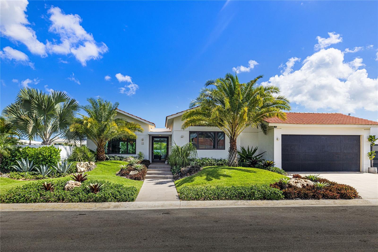 Welcome to this stunning, single-story home featuring the sought-after "Casona de Lago" floor plan. Built new in 2019, the main structure features 4 bedrooms, 4.5 bathrooms, and approximately 4,000 square feet of living space. A separate casita adds approximately 300 square feet of additional space that includes a full bathroom, a storage closet, and space that can be used for a 5th bedroom, a home office, or a fitness area.
The generously sized heated pool (complete with four waterfalls, a beach landing, and a relaxing hot tub) as well as the super-fun, in-ground trampoline easily fit on this especially large, 1,005 square meter lot that still has plenty of open yard space left over.
The lush, professionally designed landscaping package, complete with irrigation and lighting throughout make this property feel like an oasis both day and night! Plus, the recently installed new windows and exterior doors with all their open expansive glass let the light and views pour into the home, creating an exceptional sense of connection between the indoor and outdoor spaces.
The home is very conveniently located near the community’s west gate and the Doctors' Center Hospital Orlando Health. The attached two-car garage has been updated to include an electric car charger and a new perforated garage door to keep things cool. A parking pad for a third car was also added and incorporated into the landscape design.
Offered fully furnished, this move-in ready home combines elegant design, modern upgrades, and outstanding outdoor amenities to create a truly exceptional living experience.