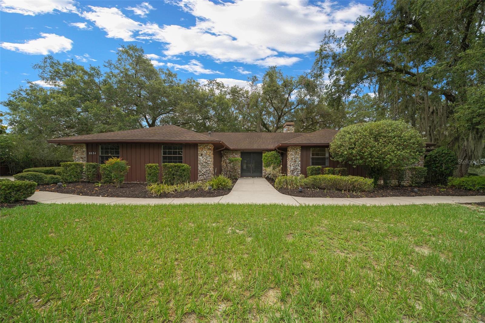 10 Rare Acres Seamlessly Connected to the Grand Oaks Equine Resort. POTENTIAL IS UNLIMITED.
Welcome to a once-in-a-lifetime offering: an iconic 10-acre estate steeped in equestrian prestige, grace, and historic soul. Formerly the private sanctuary of Gloria Austin — visionary founder of the world-renowned Grand Oaks Resort — this property is more than land and buildings; it is a living chapter in the story of American carriage driving and refined country living.
Tucked beneath a canopy of ancient oaks and bordered by the serene water views of neighboring Grand Oaks, the estate whispers of timelessness. Its classic Southern ranch-style home exudes warmth and ease, with every window framing peaceful vistas — moss-draped trees, sunlit pastures, and the soft shimmer of water beyond.
At the heart of the farm lies a remarkable signature barn that once cradled Gloria’s private carriage museum, standing as a tribute to her passion and legacy. The historic equestrian library remains, a soulful space echoing stories of the past. The building also features a charming two-bedroom apartment, ideal for guests or caretakers.
A second barn, beautifully repurposed for entertaining, offers a full kitchen, two open-concept gathering rooms, and seamless flow to an expansive patio under the oaks — perfect for al fresco celebrations or serene twilight dinners. Just across the barn aisle, a two-room apartment with full bath and laundry provides additional, flexible accommodations.
Lush, mature landscaping envelopes the estate, creating natural privacy and a sense of sanctuary rarely found. Whether imagined as a boutique equestrian retreat, private residence, or a continuation of its storied purpose, this property invites you to steward a legacy — and live amidst its grace.
THIS PROPERTY HAS POTENTIAL OF MANY USES, THE LIBRARY WOULD ACCOMMODATE UP TO 12 ANTIQUE CARS,WITH EASY ROLLUP DOOR ACCESS- The PARTY BARN and ARPARTMENTS would make one of a kind AIR B&B,, THIS IS A PROPERTY YOU CAN HAVE YOUR BUSINESS, YOUR HOBBIES AND A FABULOUS FAMILY RETREAT. It's truly like none other, come take a look.
