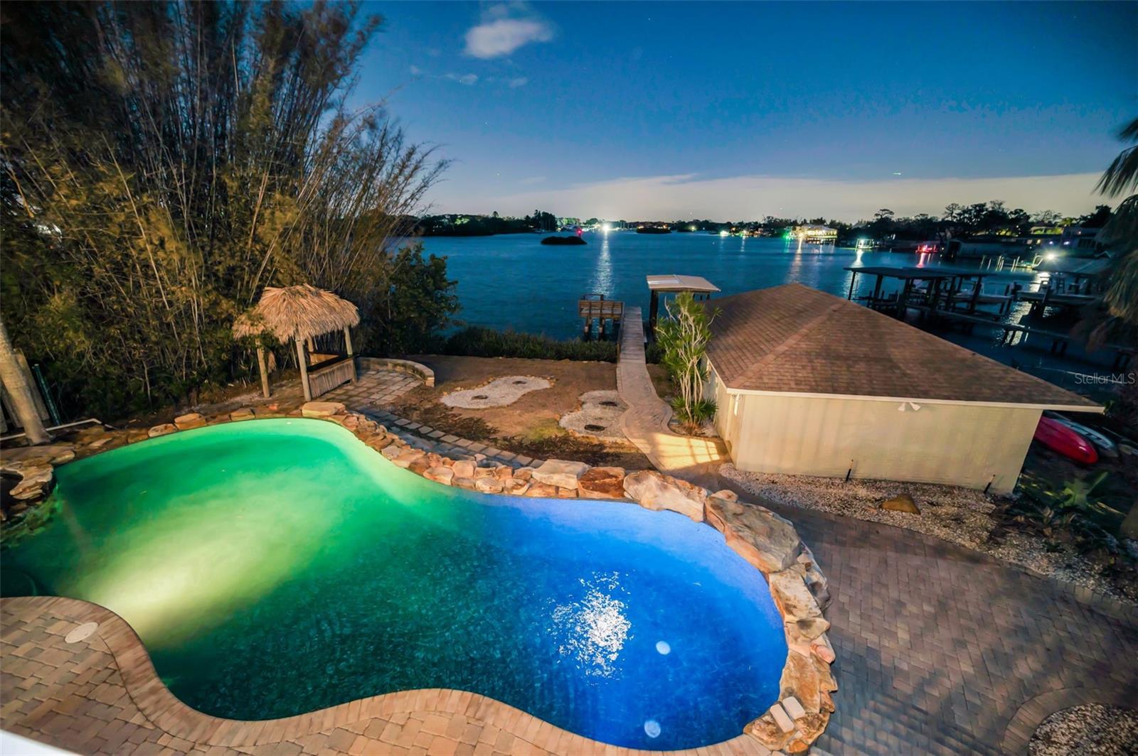 DOLPHIN COVE ESTATE! Truly unique, comprising of 3 detached structures, each with private residences. This magnificent estate home is a rare find in north Pinellas County, located in the Historic City of Tarpon Springs. Perfectly situated on the most desirable waters of the Anclote River, built high above any recent flood waters (X Zone with no flooding on any structure). The estate is comprised of three structures: Main House with 4 bedrooms, 4 baths (3 full, 1 half), and the main living areas; the Boat House or in-law suite with kitchen, bath and private entry; and the Detached, 3 bay garage with rough plummed 2nd floor living space, private parking and private entry. Spectacular views abound from almost every room revealing open views of the river frontage, distant marinas and protected islands that welcome exotic birds from around the world. This property offers an unmatched feeling of peace and serenity! To the chefs delight, you will find the gourmet kitchen with top end appliances, stone countertops, and unique honey marble flooring. The floor plan is traditional with some of the largest rooms you will find in any residential home. Window treatments included plantation shutters on the first floor. Two fireplaces; the living and family room with other built in features. So many bonuses to the property: the very customized pool with large boulder landscape; detached in-law quarters; detached garage with private entries; rough plumbed second floor that is ready to become your dream space. All nestled along the banks of the Anclote River. Share your views morning and afternoon with dolphins, manatee, shore birds, eagles, and more. The lifestyle this property offers is certainly special and not often available.