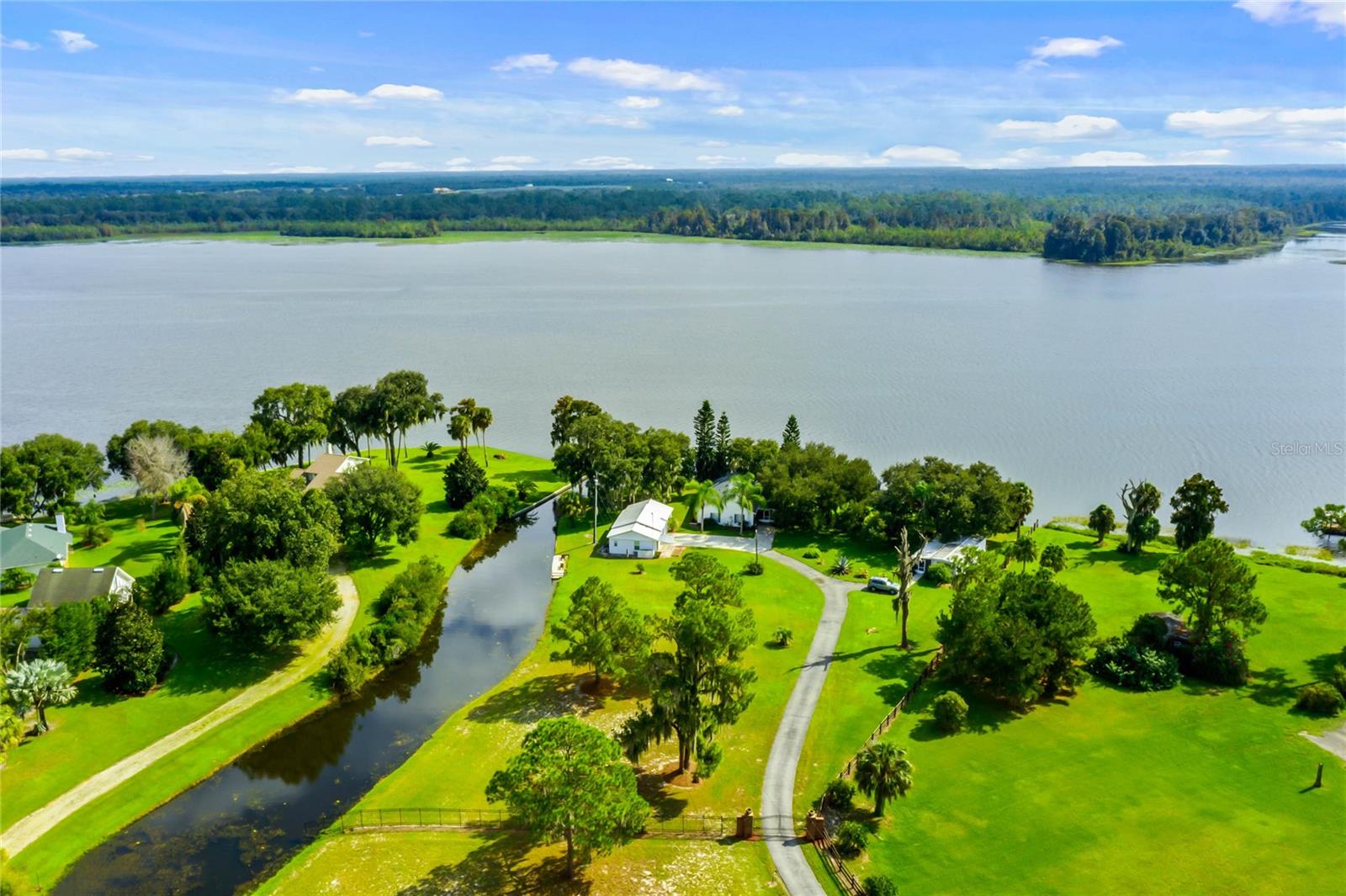 Welcome home to your future lakefront retreat!
This enchanting property offers breathtaking views of Lake Pierce and sits on nearly 2 acres of lush, tranquil land. Designed as a family compound, it features a main house, two studio apartments, and a 2-bedroom, 1-bath mobile home, making it a truly unique and versatile lakeside haven.
The main residence offers 2 bedrooms and 2 bathrooms, thoughtfully positioned to maximize the stunning waterfront views. The eat-in kitchen includes a center island, oak cabinetry, and a reverse osmosis water filtration system. The expansive great room is adorned with French doors that open to a screened-in lanai, nestled under the shade of a majestic oak tree and surrounded by lush tropical landscaping.
The primary bedroom suite includes dual closets and a private ensuite bathroom. The inviting front porch provides the perfect spot to relax and soak in the inspiring views of Lake Pierce.
Because the property spans both the lakefront and canal, it offers an excellent opportunity for floatplane access—a rare and valuable feature for aviation enthusiasts.
The 3-car garage includes enough space for a work shop or extra storage space.
Each of the two studio apartments features: Tile flooring, Ventless air-conditioning systems, Remodeled bathrooms, Tankless water heaters and Updated electrical panels
The 2-bedroom, 1-bath mobile home is being offered fully furnished and turn key ready. Featuring a screened-in porch, new hot water heater (2024) and Off-street parking.
Additional Upgrades & Amenities: Main house roof replaced in 2018, New 3-ton AC unit (2024), New water heater (2024), Hurricane shutters, Utility room, Canal-front dock, Irrigation system with new Rainbird control panel, Water filtration system, Paved driveway, Private, gated entrance.
A Tranquil Lakeside Sanctuary Tucked away behind a private gate, this picturesque retreat radiates Old World charm and peaceful seclusion—the perfect escape from the hustle and bustle of modern life. Conveniently located just 45 minutes from Disney, it combines privacy, versatility, and access to nature in one extraordinary package.