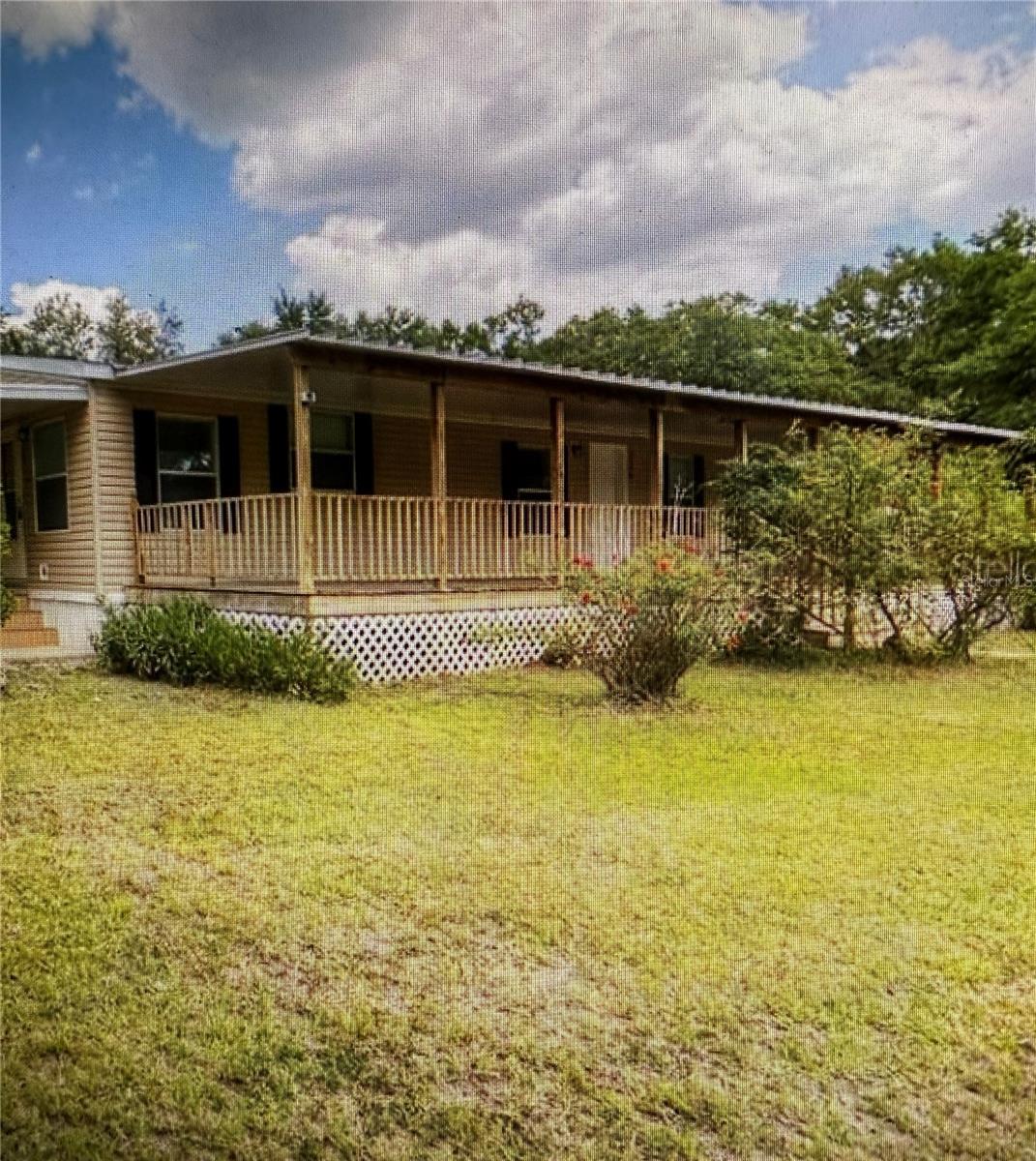 4 bedroom, 2 bath, 2 carport home with that country feel you have been looking for has just been listed. Very private fenced 2.18 acres offering maximum privacy and plenty of room to store a boat, RV or trailer. Gator Country Dr. is a small, paved, dead-end country road, so traffic will be minimal. This property offers a huge 10 x 56 covered front porch that has plenty of room for all your friends and family at the next summer BBQ. Large 25 x 27 covered carport with concrete slab. Beautiful oak (engineered wood) laminate floors flow throughout the home. Custom crafted real wood maple cabinets, tiled backsplash with granite counter tops with a double beveled edge and polished bottom. To tie the kitchen together, stainless steel GE range, microwave and dishwasher. The master bath offers a large tiled walk-in shower. Both baths have real wood vanities and matching granite. The home includes a reverse osmosis water softener system. ceiling fans in most rooms. No HOA or CDD.