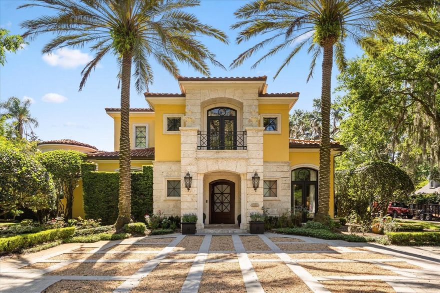 Extraordinary Waterfront Neoclassical Italian Estate situated on a prime .71-acre corner lot in one of Winter Park's most sought-after locations. This 7,916 SF property includes a main residence of over 7,100 SF, a detached guest house, and a poolside catering suite. The private covered boat dock is located just steps away, across the street, in the historic Kraft Azalea Garden, providing direct lake access with boat and personal watercraft storage on Lake Maitland, without the upkeep of a waterfront backyard. Inside, fresh neutral interiors and beautiful landscaping frame elegant arrival and living spaces. The thoughtful layout offers 5 bedrooms and 5 full plus 4 half baths, including a 550 SF guest house. Expansive entertaining areas flow seamlessly to a private courtyard with a heated pool and spa, covered dining, outdoor grill, wood-burning fireplace, and multiple terraces. Highlights include a grand primary suite with dual bathrooms and closets, a two-story wardrobe with an office in one of the primary closets, an impressive entertainment room, and a gourmet kitchen outfitted with Viking appliances, a newly replaced double oven, and a trash compactor. For large-scale entertaining, the detached pool house doubles as a catering suite with prep sink, refrigerator, and wall-to-wall storage. Built by renowned builder Charles Clayton, the home is a masterpiece of solid block construction and timeless detail featuring imported Parisian fireplaces, solid marble columns, both marble and travertine floors, and Venetian plaster walls. A new barrel tile roof (2023) adds lasting value and peace of mind. Ideally located across from Kraft Azalea Garden and near Rollins College, the estate offers a rare combination of waterfront tranquility and walkable access to Park Avenue’s world-class dining, boutiques, and museums. The Winter Park Racquet Club is also just a short golf cart ride away. This is an opportunity to acquire a legacy property at a fair value, with the heaviest aesthetic updates complete and future equity poised for growth.