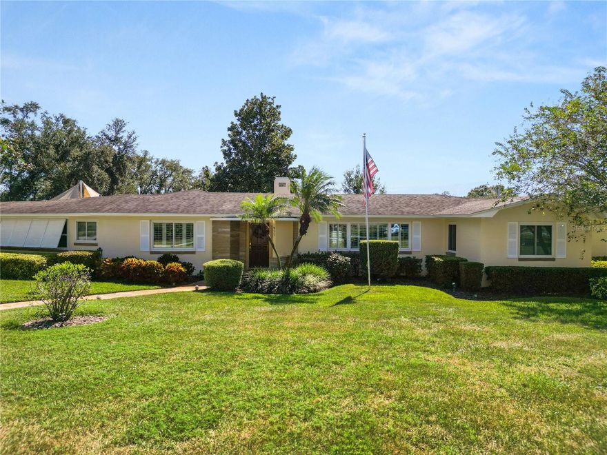 Modern Upgrades, Vintage Character — The Best of Both Worlds!  Where Mid-Century Charm Meets Modern Comfort. A Cherished Family Home — Impeccably maintained for Over 50 Years.  This EXQUISITE Mid-Century Modern Beauty situated on .65 Acres.  Discover timeless charm and exceptional care. From the flagstone walkway leading from the street to the front door. Every detail reflects pride in ownership and thoughtful updates over the years. Situated on three spacious lots totaling .65 acres. This 3-bedroom, 2.5-bath home sits on a corner lot, with a fully fenced backyard and lot surrounded by mature landscaping and hedges for privacy. Inside, you’ll find beautiful oak hardwood floors in most of the home, pine flooring in the kitchen and half bath. The two bonus rooms, one off the formal living room has flagstone flooring, and the other bonus room off the kitchen has quarry tile. Both rooms are a peaceful space to unwind.  The kitchen is a focus point with solid wood cabinetry, granite countertops, a built-in China cabinet, and new Samsung stainless-steel appliances (2019). The sunny breakfast area offers panoramic views of the lush backyard through new windows installed in 2016. California Plantation shutters add elegance to the main bedroom, living room, and dining room (installed between 2005–2007). The formal dining room features a charming chair rail. The family room boasts a wood-burning fireplace, built-in shelving, and a wet bar which creates the perfect space for entertaining family and guests, plus a small office.  Recent updates include Roof replaced in 2019, 2 new Air Conditions 2021, Deep irrigation well installed in 2012 (250 ft depth) new windows in living, dining, and main bedroom 2016-2022, The backyard oasis is truly special — featuring a large wooden deck with sunshade sails to protect from UV rays. A serene koi pond featuring waterfall, automatic water refill system and lighting for evening enjoyment. There’s also a custom lattice enclosure with automatic watering, perfect for displaying a staghorn fern or lush plants, with an avocado and mango tree producing delicious fruit. Additional highlights include a spacious laundry room with ample cabinetry, garage with storage room, and a rare reinforced concrete basement (10’ x 20.8’) equipped with shelving on both sides and a sump pump for peace of mind. This extraordinary home blends mid-century design with modern upgrades, creating a warm and welcoming ambiance both inside and out. Come encounter this one-of-a-kind property — where character, quality, and care come together to create your dream home in the heart of Lakeland!  All measurements are approximate and must be verified by buyer.