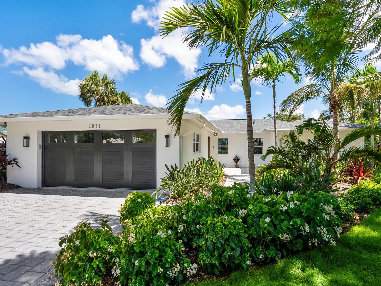 Designer waterfront retreat on Siesta Key. Welcome to your dream coastal getaway! Tucked away on a quiet cul-de-sac, just moments from the world-renowned, powdery quartz sands of Siesta Beach, this impeccably renovated and landscaped waterfront home captures the essence of laid-back luxury and island living. Boaters will delight in the deepwater Grand Canal access—just one fixed bridge to Sarasota Bay and the Intracoastal Waterway, with direct Gulf of Mexico access. This fabulous single-level, three-bedroom, two-bath residence offers an open and airy floor plan filled with natural light, making it ideal for both full-time residence and an exceptional vacation retreat. A stunning 2023 designer renovation has infused the home with texture, warmth, and playful sophistication. From natural materials and artistic wallpaper to colorful accents and layered finishes, every detail is thoughtfully curated. Upgrades include new flooring, kitchen, bathrooms, plumbing, lighting, electrical systems, and front and garage doors. Enter through the statement front door into a welcoming foyer that opens to the expansive living room, featuring sleek, floating built-ins. The heart of the home is the striking kitchen and dining space, featuring a custom terrazzo island, quartz counters, Wolf and Miele appliances, and handcrafted cabinetry that offers generous storage. The island’s induction cooktop, drop-down exhaust fan, and bar seating blend form and function beautifully. A dedicated bar area with a wine cooler enhances the entertaining experience. The wide plank engineered oak flooring flows throughout, uniting each space with warmth and elegance. The spacious waterfront primary suite is a serene escape, complete with a spa-inspired bath, dual sinks, and a walk-in shower with private access to the pool. A thoughtful split floor plan provides privacy for two guest bedrooms and a second full bath. Even the laundry room is a showpiece, featuring art tile, a stacked washer and dryer, a beverage cooler, and whimsical details. Additional features include remote-controlled blinds, reverse osmosis in the kitchen, impact glass doors, windows, and garage door, an air-conditioned two-car garage with a paver driveway and walkways, Leaf Guard gutters, a 2023 HVAC system, 2023 attic and exterior insulation, and a 2020 roof. Seamless indoor-outdoor living begins with sliding impact glass doors that lead to the covered lanai and an oversized paver deck. Enjoy alfresco dining by the heated saltwater pool, resurfaced and retiled in 2022 with a sun shelf and spa also added for lounging. The lush, tropically landscaped backyard is fully fenced with faux turf, a putting green, and a fenced dog run, making it ideal for relaxation or play. Boating and water activities are a breeze from your private dock with a 14,000-pound remote-controlled lift, kayak launch, and seawall (2022). Just 15 minutes to open water, you'll savor days of fishing, paddleboarding, and Gulf cruising—right from your backyard. Ideally located near Siesta Village’s charming shops and restaurants, yet just minutes from mainland amenities, top-rated schools, and vibrant downtown Sarasota. Grab your flip-flops and sunscreen; this one-of-a-kind home offers the complete island lifestyle.