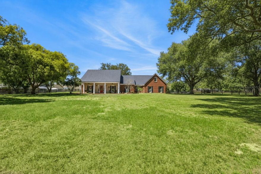 Tucked away on over 2.25 acres in the highly sought after equestrian community, The Trails of Montverde, this stunning 4 bedroom, 3 bath estate blends timeless traditional design with luxurious modern updates offering the kind of property and privacy that is getting harder to find in Central Florida. With just under 3,500 square feet, this home offers a thoughtfully designed floor plan that creates separation and privacy between spaces while still maintaining an inviting, natural flow throughout the home. No cavernous warehouse style open concept here, this one has warmth, character, and rooms that actually make sense. The heart of the home is the beautifully renovated kitchen, completed in 2022, featuring gorgeous marble countertops, updated finishes, and a layout designed for everyday living. The bathrooms were also fully remodeled in 2022 and feel straight out of a luxury boutique retreat, especially the stunning primary en-suite featuring a standalone clawfoot soaking tub and custom primary closet. Engineered hardwood floors run throughout the home, adding warmth and elegance, while the dedicated office provides the perfect work from home set up. Upstairs, the private fourth bedroom with its own en-suite bathroom creates an ideal guest suite, in-law space, or teenage hideaway. Step outside and the property truly unfolds into something special. The fully screened pool area is designed for peaceful outdoor living with a tranquil waterfall feature and expansive entertaining space overlooking the property with no rear neighbors in sight. Horse lovers will appreciate the 4 stall barn, equipt with an office with AC, a feed room and two paddocks.  The Trails of Montverde is one of the few true equestrian neighborhoods in the area, offering over 5 miles of private riding trails along with a private community riding arena. Whether your dream is horses, chickens, goats, gardening, or even keeping bees, this property gives you the flexibility and space to create the lifestyle you’ve been wanting. Additional major updates include a 2023 roof, septic system recently pumped and inspected prior to listing, and a rare commercial grade in house fire sprinkler system for added peace of mind. This is more than a home. It’s the kind of property that feels like its own slice of heaven the moment you drive down the oak canopied driveway.