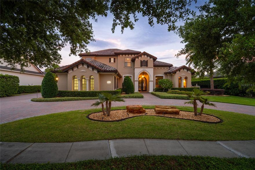 Welcome to this stunning lakefront custom home located in the highly sought after guard-gated community of Lake Forest. Offering 5 bedrooms plus a private office, this exceptional residence captures breathtaking water views from nearly every room, blending luxury living with serene waterfront beauty. The home also features double-pane windows throughout, enhancing energy efficiency and comfort. Designed for both everyday living and grand entertaining, the home features a spacious first floor owner’s retreat, along with an additional guest bedroom, private office, and a custom home theater. The theater includes nine reclining tiered theater chairs, a bar, a 10-foot screen, Sony Atmos surround sound system, custom lighting, and automated blackout shades, all controlled with the touch of a button. The gourmet kitchen is designed for both everyday living and entertaining, featuring a large center island with breakfast bar and prep sink, gas cooktop, built-in ovens, reverse osmosis water filtration, and an oversized walk-in pantry. The adjoining family room showcases a custom built-in entertainment center and dramatic corner sliding glass doors that fully retract, creating seamless indoor-outdoor living. Step outside to your private resort-style lanai with a sparkling pool and spa, paver patio, built-in summer kitchen, gas fireplace, and expansive lake views, perfect for entertaining or relaxing in a peaceful waterfront setting. The second floor offers three additional bedrooms, two bathrooms, a second laundry room, and a spacious bonus room that opens to a 20x20 balcony overlooking the water. Recent updates include replacement of all HVAC systems (three replaced in 2024, one in 2023, and one in 2018) with a transferable maintenance contract. Additional upgrades include a hybrid 80 gallon hot water heater (2022), exterior paint (2019), spray foam insulation above the garage, an updated primary bathroom (2022), crown molding throughout, whole home automation, and an ADT security system. Car enthusiasts and hobbyists will appreciate the oversized four-car garage with a top-of-the-line air-conditioned workshop. Along with an insulated air conditioned attic and additional storage, this space provides approximately 1,300 square feet of additional air-conditioned space not included in the listed square footage. Community amenities include a 10,000 sq ft clubhouse, fitness center, Jr. Olympic pool, heated spa, fishing pier, tennis and pickleball courts, playground, and a 55-acre private spring-fed lake. Designated as a National Wildlife Habitat, the community also features scenic walking areas and a beautiful butterfly and pollinator garden. Conveniently located near major highways, shopping, dining, and top-rated Seminole County schools, this lakefront home offers an exceptional blend of luxury, privacy, and lifestyle.