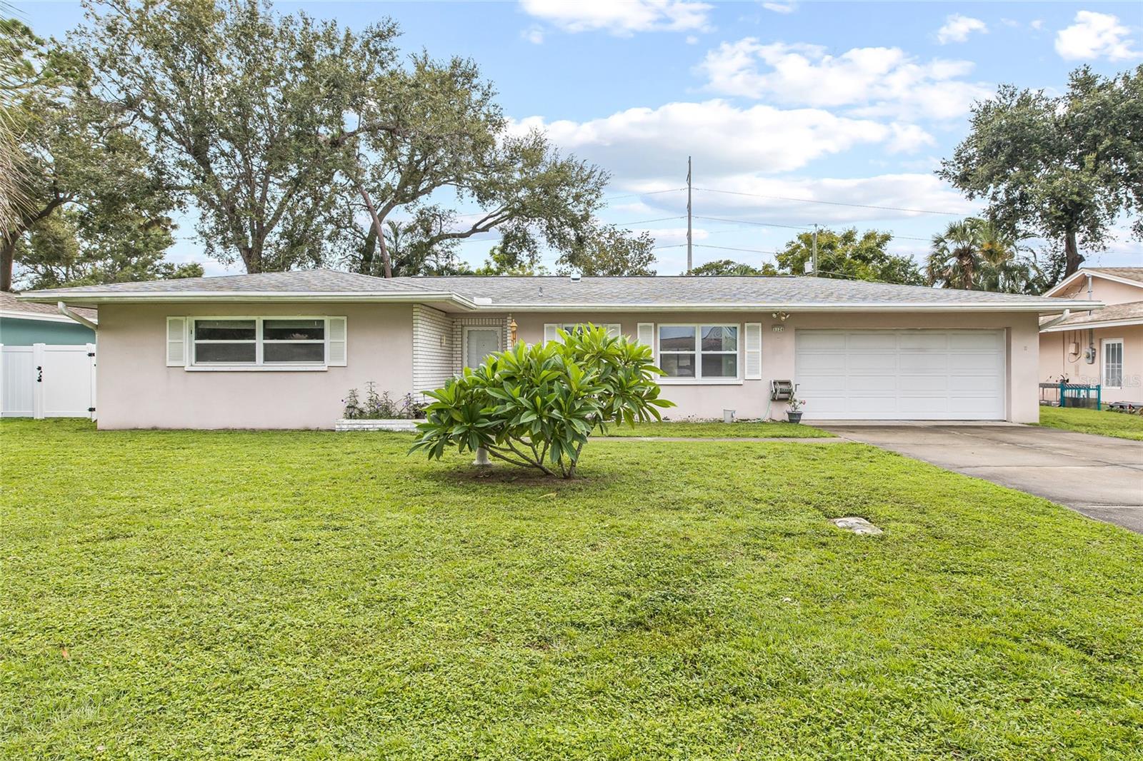Welcome to Suburban Estates—just six miles from the beach yet comfortably outside the flood zone. This home weathered recent storms without any issues. Set on a picturesque tree-lined street, it offers nearly 1,500?sq?ft of living space, including a bright 288?sq?ft Florida room. Inside, you’ll find extra-large bedrooms and gleaming wood floors in the living and dining rooms. Outdoors, enjoy a fenced yard with a quality vinyl storage shed and an oversized two-car garage complete with storage and a workshop area. Ideally positioned close to Tampa International Airport, International Plaza, and the Gulf beaches, this home offers the best of both worlds: relaxed coastal living and quick access to Tampa’s big-city conveniences—all at a great price.