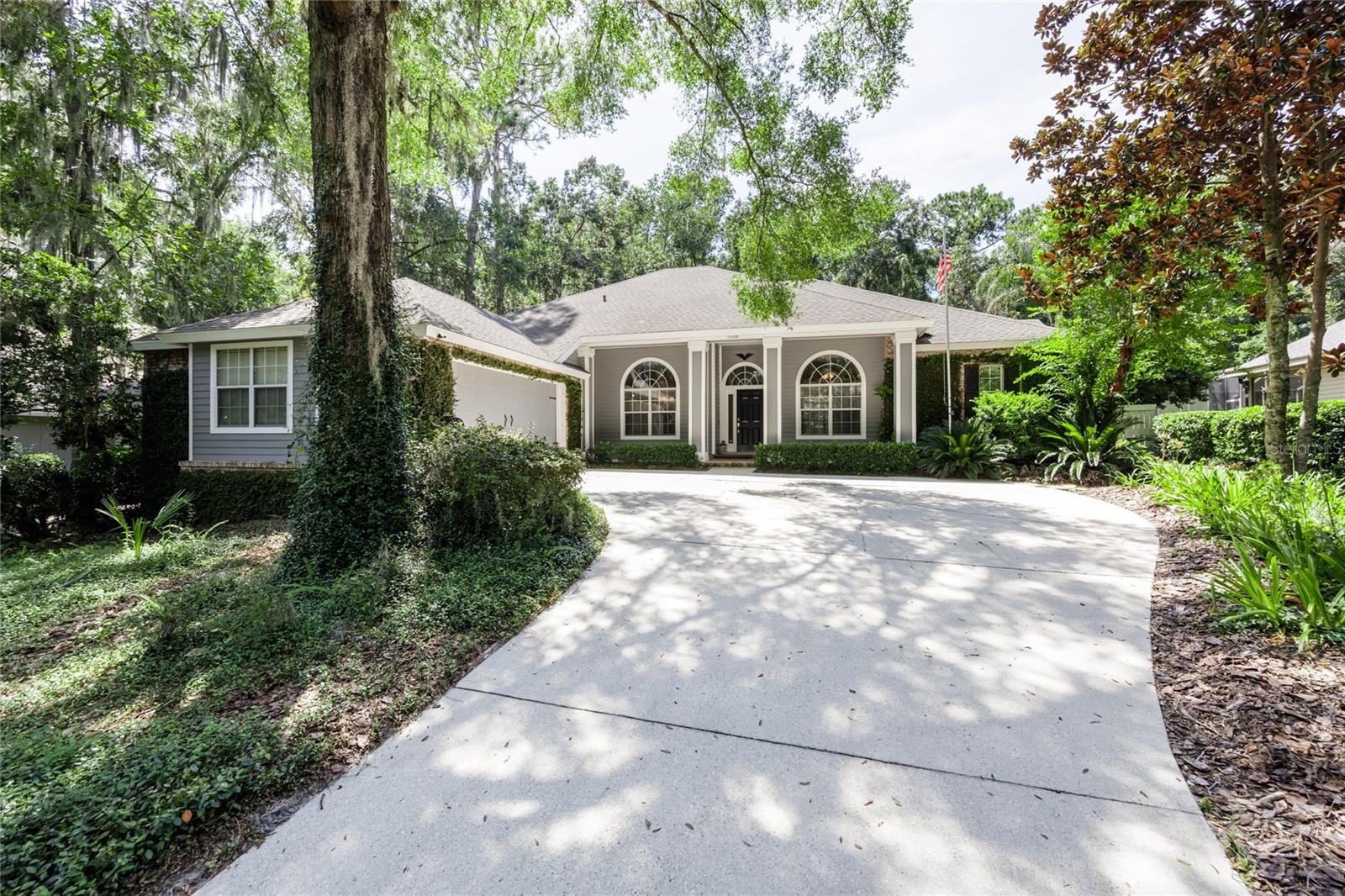 Welcome to this beautifully maintained 4-bedroom (4th bedroom off the Primary could be an office), 2.5-bath, 2,604 sq. ft. home with a lap pool and hot tub, located in Bueller’s Way Haile Plantation.
As you enter through the pavered front porch, your eye is immediately drawn through the foyer and formal living room—featuring wood flooring—out the French doors to the covered paver lanai, sparkling pool and spa, and fenced backyard. The outdoor space also includes an additional paver patio with a fire pit and a pond with a fountain. Further in the back yard is nice corn hole or horse shoe area. Shaded and inviting, the yard is perfect for entertaining or simply relaxing.
Inside, the kitchen is a chef’s delight with granite counters, a skylight, a large island with breakfast bar, gas range, stainless steel appliances, and a walk-in pantry. The kitchen flows seamlessly into the family room, complete with a gas fireplace, custom built-in bookcases, and a sunny breakfast nook overlooking the lanai. Just beyond the kitchen you’ll find a built-in desk area, the laundry room, and two bedrooms that share a full bath with a walk-in shower.
On the opposite side of the home, the spacious primary suite features tray ceiling details with lighting, private access to the lanai, and a luxurious en suite bath with a freestanding soaking tub, walk-in shower, double granite-topped vanities, separate water closet, and a large walk-in closet.
Additional highlights include a formal dining room, a dedicated office (or fourth bedroom) with built-in bookcases, and a convenient half bath with direct access to the lanai and pool.
This home is carpet-free throughout, offers abundant natural light, crown molding, and a durable brick-and-Hardie exterior. A short walk from both Hampstead park and Hawkstone Golf and Country club make this the perfect home located right in the middle of Haile Plantation.