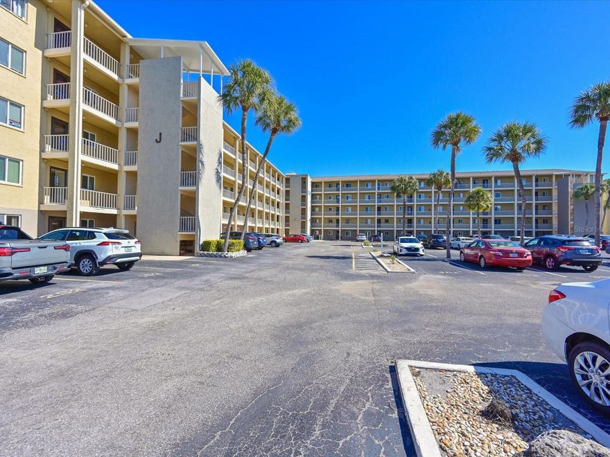 Outstanding Bayshore On The Lake condo, pictures tell it all! If you are looking for a place in the sun, this TURNKEY FURNISHED unit is hard to beat. This unit is special and very unique! Updates include low profile coffered ceilings, remodeled kitchen, new microwave, new disposal, recessed lighting in several rooms, remodeled bath with new shower, toilet, vanity, and fixtures, keyless entry, new front storm door with clear glass full view and pull down window for screen. Blink video doorbell, AC 2022. Large lanai has a beautiful and tranquil lake view, vinyl enclosed, and stack washer/dryer on lanai. 55+ community with clubhouse and pool. Walk to shopping, restaurants, and much more. Close to Gulf beaches. Make your appointment today to preview this move-in ready gem of a condo.