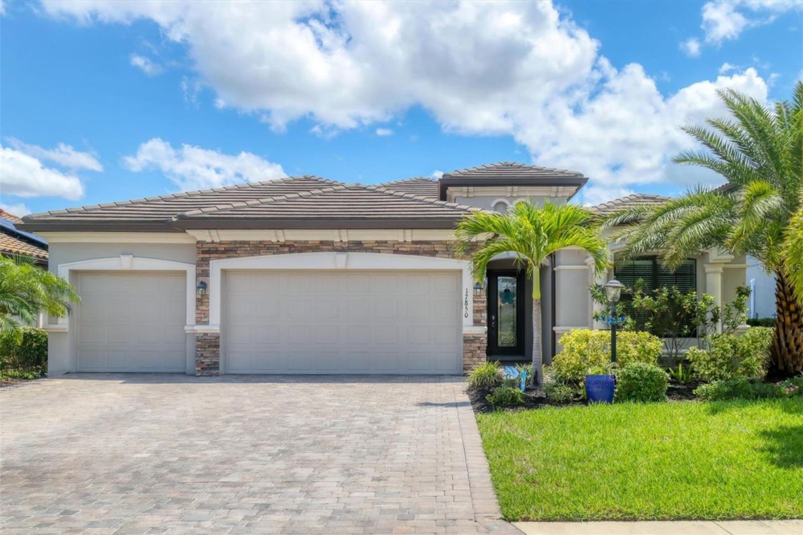 Welcome to your Florida dream home in Polo Run — the first solar-powered neighborhood in Lakewood Ranch. This stunning Lennar Princeton II model offers a blend of luxury, energy efficiency and peace of mind, all set on a premium homesite with breathtaking sunrise and sunset views over the water. This home features four spacious bedrooms and two baths within an open floor plan. Elegant architectural details include arched doorways, crown molding, neutral tile flooring and tray ceiling with custom wood inlays. This home is designed for gathering with the central, airy great room, featuring a newly installed shiplap accent wall and built-in electric fireplace with shelving (2023). Right off the great room, the kitchen offers a setting for entertaining with its angled island, pendant lighting, white cabinetry, stainless steel appliances and a cozy breakfast nook overlooking the pool. Sliding glass doors lead to an expansive paver lanai where you can relax beside your private saltwater pool and spa, heated by solar power and updated with a new pool pump in 2023. The lanai offers spectacular water views and a tranquil setting to enjoy morning coffee and evening sunsets. The serene primary suite also enjoys sweeping lake views and features a tray ceiling, large walk-in closet and a spacious en-suite bath with dual sinks and a walk-in shower. Three additional bedrooms and a guest bath offer comfort and flexibility for family and guests. This home is filled with upgrades, including a new HVAC system and Halo UV light air purifier installed in 2023, a tankless water heater, a water softener, hurricane shutters, and a whole-home gas generator for added security and efficiency. Curb appeal abounds with a tasteful stone façade, paver driveway and lush tropical landscaping, all maintained by the HOA. A spacious three-car garage provides plenty of room for vehicles and storage. Polo Run residents enjoy a vibrant, maintenance-free lifestyle with access to resort-style amenities, including a clubhouse, resort-style pool, fitness center, bocce ball, tennis, pickleball and basketball courts. The community also features a dog park, children's playground, and a full calendar of social activities like exercise classes, water aerobics, trivia nights and card games. Conveniently near shopping, dining and with quick access to Interstate 75, this solar-powered home offers luxury, location and peace of mind in one of Lakewood Ranch’s premier communities. Don’t miss your opportunity to live beautifully and sustainably in Polo Run and schedule your private tour today.