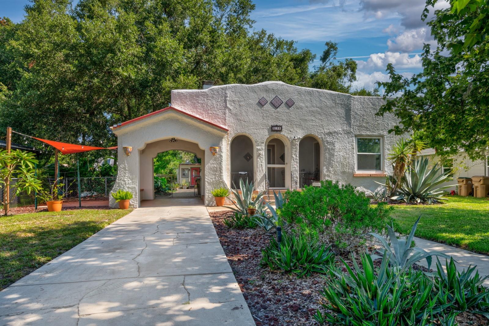 Adorable Spanish Style Vintage Bungalow in Mount Dora! Situated near the shores of Lake Gertrude and Morningside Dr. with park access to enjoy, sidewalks to stroll around the lake and beyond to downtown or Lake Dora. This home is packed with lots of character and the charm you would expect to find in a “Some Place Special” Mount Dora 20s home. Architectural statements of the era are profound and displayed with original hardwood floors, arched doorways, wide baseboards, high ceilings, built-ins, wood burning fireplace, and portico. Entering the porch you feel the warmth of another time and moving into the main home you are overtaken by a flood of beauty from the past in the fireplace, original hardwood floors and gorgeous built-ins dividing the living and dining areas. A cozy kitchen is in the back overlooking private yard, comprised of a newer cabinets, counters, appliances plus washer & dryer, eat in kitchen and own exit to the back. Two nice sized bedrooms split by a lovely bathroom with tub/shower. “The Shed” at the end of pavers is currently being used for pet grooming but is finished with power and water has many possibilities. Over time owners have added new electrical, windows, doors, cabinetry, counters, updated appliances, she shed, total fencing, irrigation, patio, pavers and so much more. A step back in time with the conveniences of today. The wood ceilings in the carport/portico and front porch are my favorites in this Historical home. Thinking about trying Mount Dora out, ready to buy your Winter home or this town is the final stop…this is a must see, come by and view this beautiful home today!