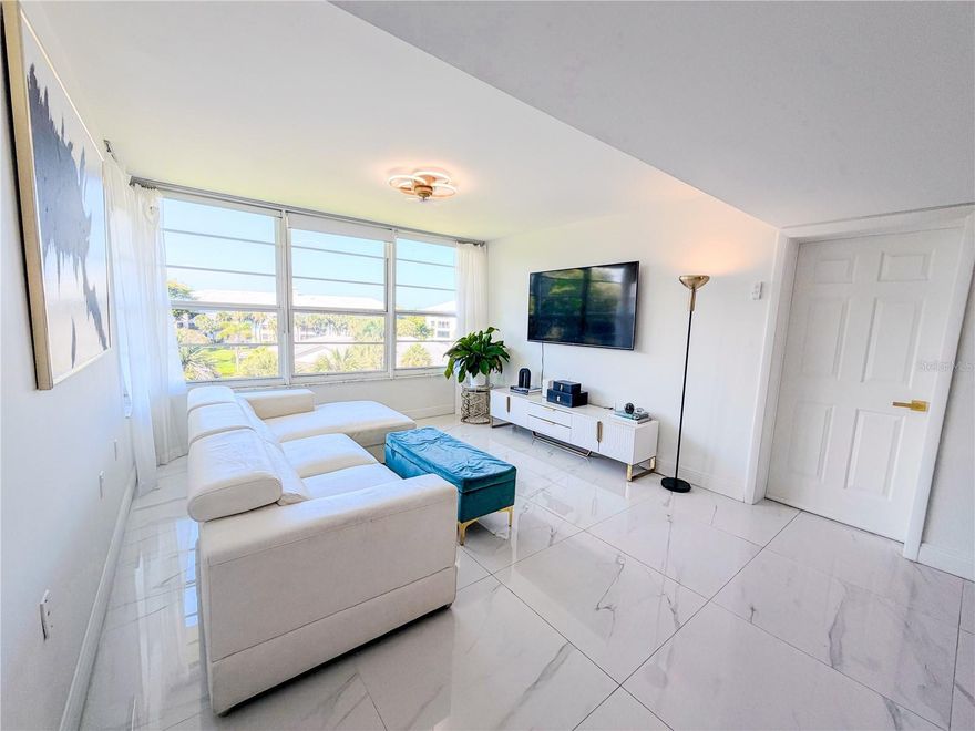 Experience elevated living in this beautifully renovated top-floor residence located in the highly desirable Whitehall community in West Palm Beach. This rare unit offers ultimate privacy with no neighbors above or on either side, creating a quiet and exclusive living environment that is hard to find.

This move-in ready apartment showcases high-end finishes, thoughtful design, and abundant natural light thanks to its east and west exposure. The expansive living area is designed for versatility and comfort, seamlessly accommodating four distinct spaces: a TV lounge, conversation area, dining room, and a stylish bar for entertaining.

The home features two spacious bedrooms, including a luxurious primary suite with a large custom-designed walk-in closet and a beautifully updated private bathroom with glass mosaic details and a modern glass-enclosed shower.

A standout feature is the extended laundry area with brand-new washer and dryer, where the additional space has been thoughtfully converted into a third bedroom or private office, offering flexibility for today’s lifestyle.

Throughout the residence, you’ll find 48” x 48” Italian porcelain tile flooring, smooth walls with premium paint, and modern ceiling fans and lighting fixtures with retractable blades and remote controls. The living room is enhanced with both blackout curtains for optimal media enjoyment and sheer voile curtains that allow soft, natural light to flow in.

The contemporary kitchen is designed to impress, featuring quartz counter tops, a sleek dark gray finish, and top-of-the-line Samsung appliances, including a 5-burner stove and microwave, along with a premium Sub-Zero French door refrigerator with internal water dispenser and ice maker.

This property also offers significant long-term value and peace of mind with impact-resistant (hurricane) windows and a new roof, which can contribute to lower insurance costs for the new owner.

This residence provides convenient access to major highways, shopping, dining, and is just minutes from downtown West Palm Beach and pristine beaches.

This is a rare opportunity to own a fully upgraded, private top-floor unit in a prime location. Schedule your private showing today.