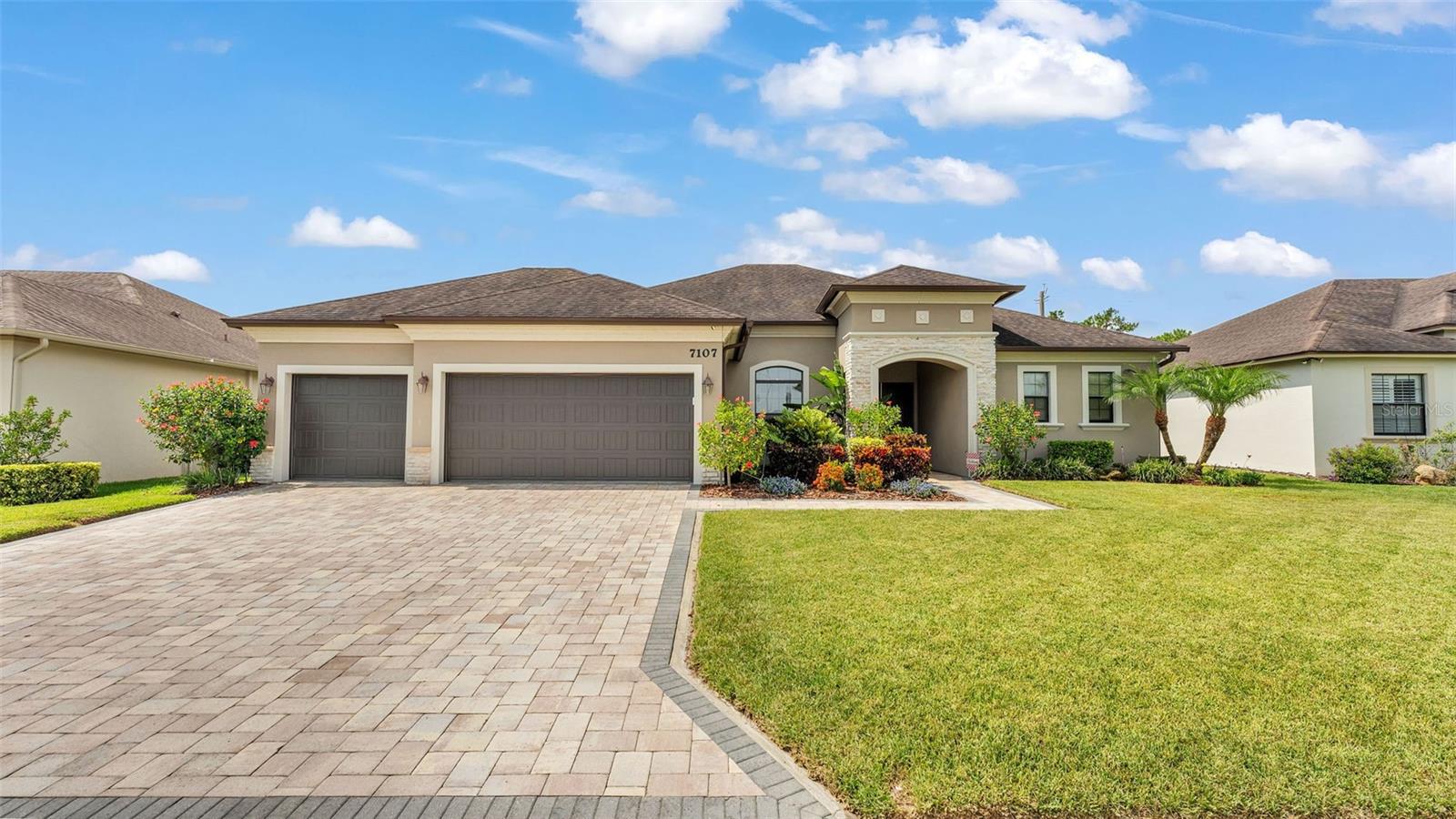 Welcome to 7107 Highlands Creek Avenue, a move-in ready, meticulously kept custom-built home by Tapia Construction, located in the desirable gated community of Highlands Creek Phase II. This beautifully maintained residence offers the perfect blend of luxury, privacy, and convenience all set on a serene 0.28-acre lot with no rear neighbors and peaceful wooded views. Boasting over 2,700 square feet of thoughtfully designed living space, this home features 4 spacious bedrooms, 3 full bathrooms, a dedicated office/flex space just off the foyer, and a 3-car garage. The exterior of the home was freshly repainted in 2025. A welcoming entryway leads to soaring 10- and 12-foot tray ceilings, crown molding, elegant archways, and wood-look tile flooring throughout the main living areas. The dining room flows seamlessly into a gourmet kitchen, complete with granite countertops, stainless steel appliances, custom cabinetry, tile backsplash, large walk-in pantry, and an oversized island with breakfast bar ideal for both everyday living and entertaining. The owner’s suite is a private retreat with a spacious walk-in closet and a spa-like bathroom featuring separate vanities, a luxurious garden tub, and a walk-in tiled shower. Three additional bedrooms offer walk-in closets and convenient access to two guest baths. Two of which share the hallway bathroom and one conveniently located at the far side of the home with it’s own private bath and pool access through the bathroom. Perfect for a guest space or in-law living space and privacy. Ample storage throughout includes linen closets and a large laundry room with built-ins. Step outside and relax in your tropical backyard oasis. The screened lanai opens to a heated saltwater pool with fountains, surrounded by travertine decking and lush landscaping. Enjoy tranquil evenings under the stars by the custom fire pit, all while overlooking a peaceful wooded view, a true resort-style setting designed for year-round outdoor living. Additional highlights include a pavered driveway and lanai, stone accents at the front exterior of the home, beautiful curb appeal, and premium finishes throughout. Located just minutes from Publix at 540A, Watson Clinic South, Lakeland Regional Health South, and easy access to the Polk Parkway, this home is ideally situated for commuting and enjoying all that Lakeland’s south side has to offer. Zoned for Valleyview Elementary, Lakeland Highlands Middle School, and George Jenkins High School, this property checks every box for families seeking top-rated schools and a vibrant, convenient lifestyle. Close in proximity to walking trails at The Highlands Scrubs. Don’t miss this rare opportunity to own a high-quality, move-in ready home in one of Lakeland’s most sought-after gated communities!
