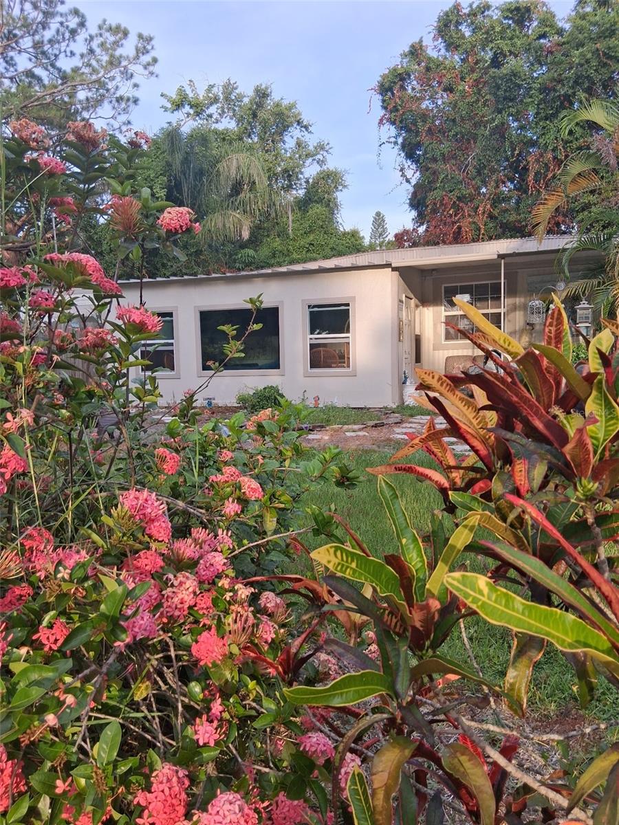 Land-Owned! No HOA, No Lot Fees! This 2 bedroom, 1.5 bath home sits on its own 100 x 60 lot and is considered real property not in a park. With no restrictions, no monthly fees, and low property taxes, you'll enjoy the freedom to truly make it your own. Park your company vehicle, RV, or boat with ease and appreciate the low overhead that comes with land ownership.
The home has been well cared for with many updates: central heat/air (2018), water heater (2022), new windows (2024-25), and a newer dishwasher (2024). Inside you'll find plenty of living space including a Florida room, a covered patio for entertaining, a renovated laundry room with hardwood cabinetry, and an 8x13 addition perfect for an office or hobby space. Outside, relax by the above-ground pool with a cabana shed, enjoy extra storage in a larger shed, and take comfort under mature oaks in a mostly fenced yard. A 2025 elastomeric roof coating helps keep things cool.
Located on a quiet dead-end street, this home offers peace and privacy while still being minutes to Madeira Beach, Treasure Island, Bay Pines VA, and within walking distance to shopping, restaurants, and bus routes. For the right buyer, this can be a true sanctuary in the heart of Pinellas. Cash only, sold As-Is.