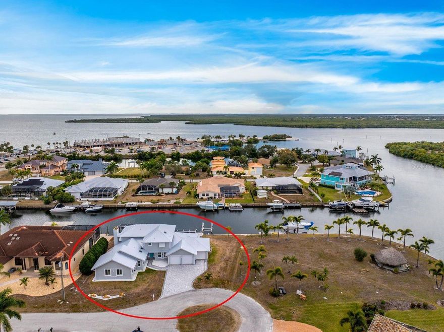 STUNNING COASTAL RESIDENCE. Experience exceptional waterfront living at this fully renovated coastal estate offering sailboat access to Charlotte Harbor in approximately 15 minutes, no bridges, just open water, stunning sunsets, and the ultimate Southwest Florida boating lifestyle. Situated on an oversized lot with 150 feet of saltwater frontage, this 4-bedroom, 4-bath residence seamlessly blends luxury with peace of mind. A metal roof, impact windows and doors, and high-quality finishes provide durability, energy efficiency, and the potential for lower insurance costs. Inside, high ceilings, French doors, plantation shutters, and coastal accents create a bright, welcoming atmosphere. The chef’s kitchen showcases quartzite countertops, stainless steel appliances, solid wood cabinetry, open shelving, and a spacious breakfast bar ideal for entertaining. The primary suite offers a private retreat with dual vanities, a glass walk-in shower, Jacuzzi soaking tub, steam room, built-in wet bar, and a private balcony overlooking tranquil canal views. Outdoor living is exceptional, featuring a heated saltwater pool, expansive paver deck, and serene water feature designed for relaxation and entertaining. Boaters will appreciate the composite dock, 16,000-lb boat lift, and new seawall, providing both convenience and long-term waterfront protection. Conveniently located near downtown Punta Gorda, golf courses, dining, Punta Gorda Airport, and Gulf beaches, this home offers the perfect blend of luxury, lifestyle, and location.