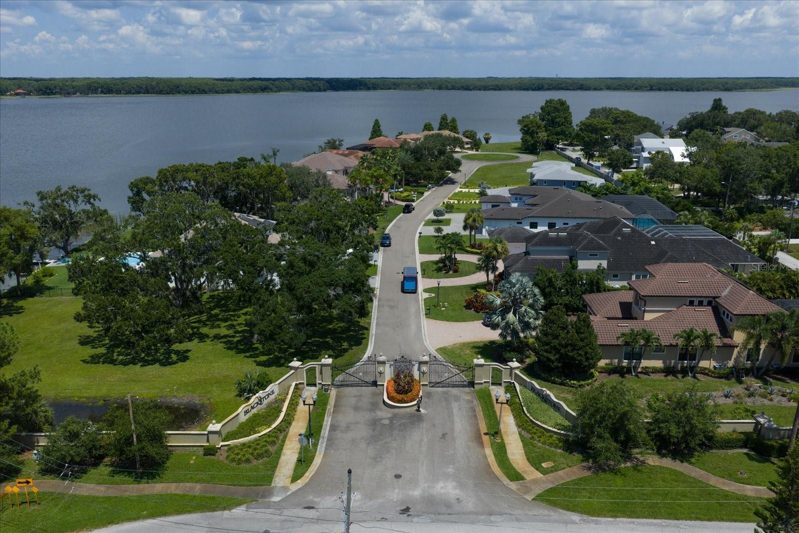 Discover an incredible opportunity to create your dream home in the prestigious Blackstone gated community on beautiful Lake Tarpon. This expansive lot offers a rare chance to build in one of Tampa Bay’s most coveted waterfront neighborhoods, surrounded by exquisite custom estates and timeless architecture.
Enjoy a limited water view of scenic Lake Tarpon from your future home, with full water access to launch kayaks, paddleboards and canoes. Take advantage of Blackstone’s elegant setting, where homes are thoughtfully designed with a minimum of 3,500 square feet to preserve the upscale character of the community. With its private street, serene setting and stunning residences, Blackstone stands out as a premier address for discerning buyers. Location is everything—just off US 19 north of Alderman Road, you’ll have effortless access to dining, shopping, and major thoroughfares while enjoying the peaceful retreat of a private, gated enclave. Lake Tarpon itself is a recreational haven, known for boating, fishing, and lakeside dining, with marinas and parks just minutes away. This lot does NOT require pilings for construction, offering a strong foundation for your vision of a luxury home. The Engineering Report has been completed. Whether you imagine a modern masterpiece or a classic estate, this property provides the ideal setting to bring your plans to life.
Don’t miss the chance to secure your place in this exclusive waterfront community—build your dream home and live the Blackstone lifestyle on Lake Tarpon.