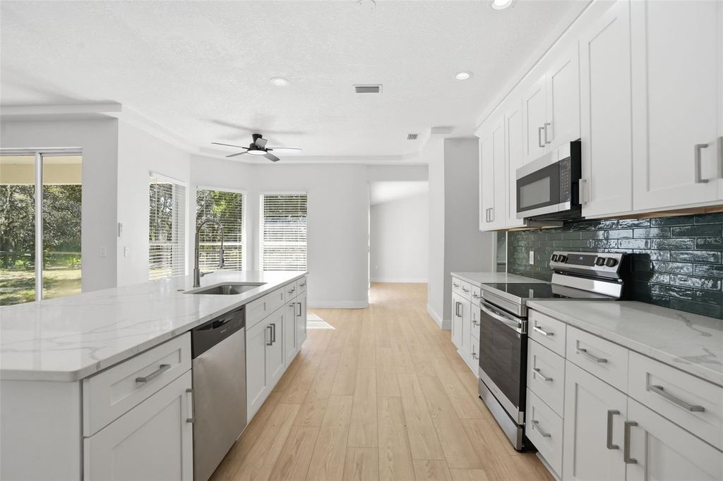 Photo of 14100 Olympic Village Lane, Brooksville, FL 34614 (MLS # W7880497)