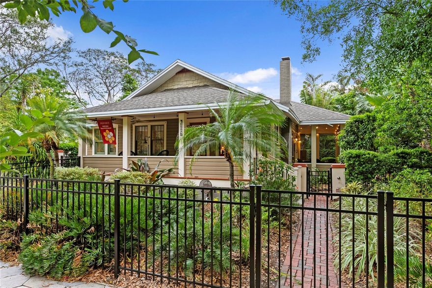 Just one block from Beach Drive, tucked within the storybook streets of Old Northeast, this two-bedroom plus den, two-bath bungalow feels timeless and quietly elevated, complete with a rare four-car garage spanning approximately 725 square feet, an unheard-of feature for the location. From the moment you go inside, the home reveals its character through warm wood floors, crown molding and original details that have been thoughtfully preserved. Sunlight filters through classic windows, casting a soft glow across the living spaces, where a gas fireplace with custom tile hearth and built-ins creates a natural focal point. The kitchen blends function with understated charm, featuring quarry tile floors, new granite countertops, custom cabinetry with thoughtful built-in features, a pullout pantry and a stainless farmhouse sink. It is further equipped with an integrated refrigerator with refrigerator/freezer drawer and interior water dispenser, a new microwave/convection/air fryer, and a retractable hood with light, along with gas cooking and a kitchen workstation. It opens with ease into the heart of the home, designed for living that feels relaxed and intentional. Just beyond, a screened dining porch offers a breezy, intimate setting that invites long, unhurried evenings. The bedrooms are peaceful and tucked away, while the den offers a flexible space for work, reading or guests. Behind the scenes, the home is equipped with modern comforts including updated HVAC, tankless water heating, storm protection, a security system with cameras, and natural gas generators serving the main home and the detached ADU, with no flood insurance required. The outdoor spaces feel curated yet effortless, with brick pathways, mature landscaping and private garden moments throughout. A detached ADU offers two bedrooms and one bath across approximately 725 square feet, complete with its dedicated parking space, ideal for guests or income potential. All this just near the waterfront and charm of downtown St. Petersburg, where daily life unfolds with a sense of ease and quiet beauty.