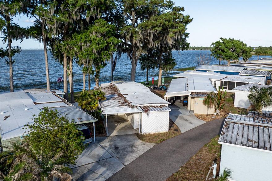 Opportunities like this don’t come around often.. Run! Do not walk to secure your slice of lakefront living!
Welcome to Unit #23 at Three Lake Mobile Home Park, offering approximately 60 feet of frontage on beautiful Lake Eustis, one of seven lakes that make up The Harris Chain of Lakes. Bring your creativity and vision to transform this space into the lake retreat you’ve always imagined.
The 2-bedroom, 1-bath home sits right along the shoreline, and whether you’re shopping for lake front living full time or a second home… You just found it!
Situated in a resident-owned Co-Op community, the property includes a carport along with a workshop and or storage area which is perfect for tools, hobbies or your boating essentials. 
Residents enjoy access to community amenities such as a clubhouse, shared lake access, and community mailboxes. Monthly dues are just $100, making this an affordable entry into waterfront living. Boat slips may also be available for lease(first come first serve), giving you convenient access to boating, fishing, and exploring the entire chain of lakes. There are endless opportunities with this home. Call today for a private tour!
