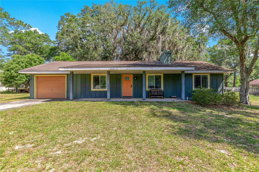 One or more photo(s) has been virtually staged. Welcome home to this inviting Craftsman style 3-bedroom, 2-bathroom residence located in the established Wright Heights neighborhood of NE Ocala. Thoughtfully designed to maximize space and natural light, this home offers an open and comfortable layout with features that make everyday living feel warm and welcoming. Step inside to a spacious living and dining area highlighted by vaulted ceilings, abundant natural light, and a fireplace with surrounding built-in shelving that creates a cozy focal point for the home. Tile flooring throughout provides both durability and easy maintenance, while additional built-in storage areas throughout the home add character and functionality. Newer double-pane windows enhance the home’s efficiency and allow natural light to flow throughout the space. The light and bright kitchen offers generous wood cabinet storage, ample workspace, and a large picture window overlooking the backyard, bringing the outdoors in and creating a pleasant setting for cooking and gathering. The primary suite includes a walk-in closet and private en-suite bathroom, offering a comfortable retreat at the end of the day. French doors open to the back patio and an oversized fenced backyard shaded by mature landscaping and beautiful oak trees, providing space to relax, garden, entertain, or create your own outdoor oasis. A covered front porch and spacious front yard further add to the home’s inviting curb appeal and welcoming Craftsman feel. Additional features include a 1-car garage and a convenient location close to shopping, dining, parks, and everyday amenities while still enjoying the feel of a quiet neighborhood setting. Schedule your private showing today and experience all this NE Ocala home has to offer.