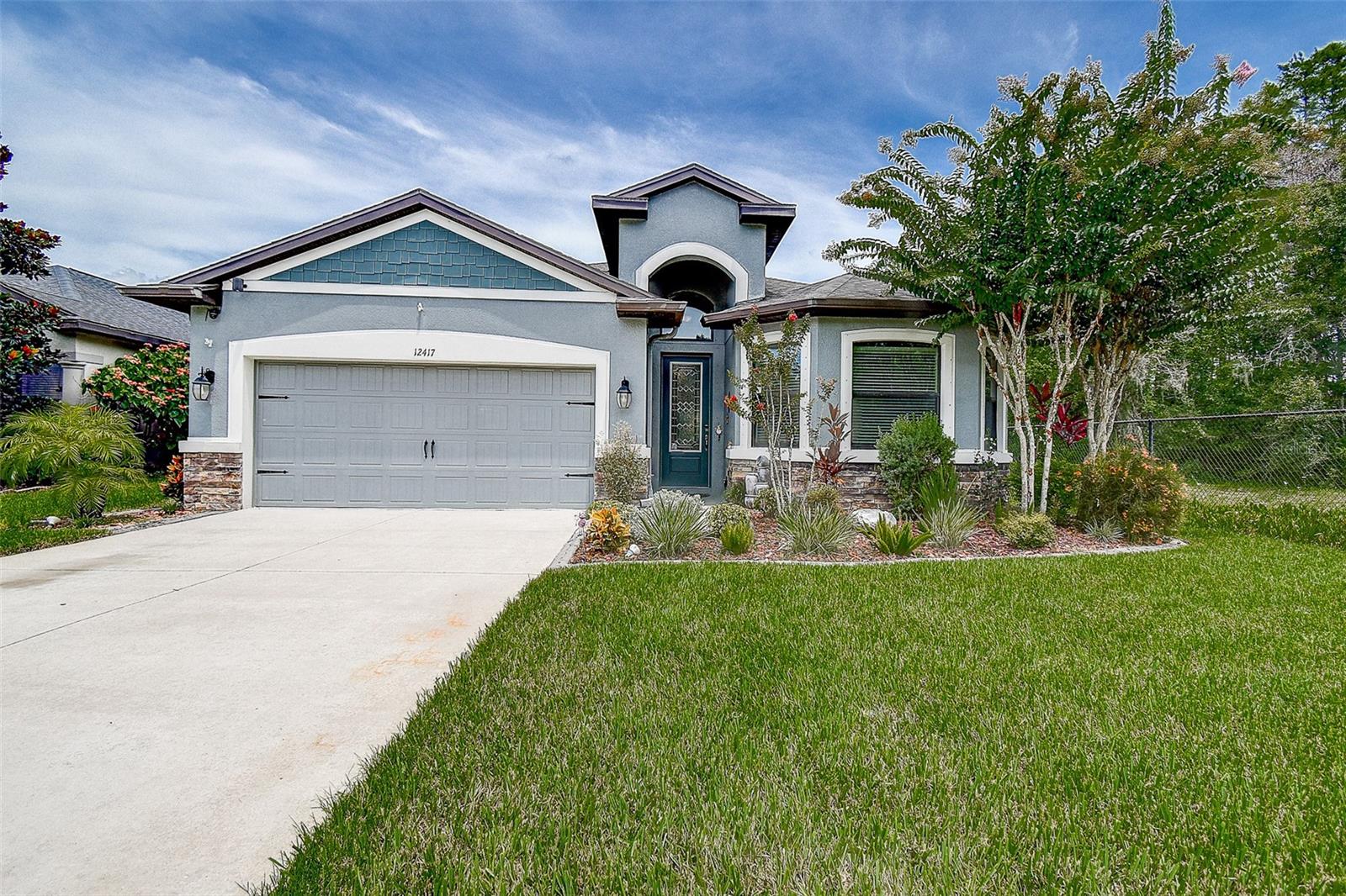 This beautifully gated community Rose Haven offers this 4-bedroom, 3-bathroom residence effortlessly combines style and functionality, offering generous living space ideal for both everyday comfort and entertaining.
Step inside to a warm, inviting interior where modern tile flooring, abundant natural light, and an open-concept layout set the tone. The spacious living area seamlessly extends into an open lanai, creating the perfect space for hosting guests or relaxing.
The chef’s kitchen is a standout feature, complete with sleek stainless-steel appliances, gorgeous 42” cherry cabinetry, up-lighting, waterfall-edge countertops, and plenty of workspace to inspire your culinary creations.
Your private master suite serves as a serene retreat, offering an en suite bath and a peaceful place to unwind. Three additional bedrooms provide flexibility for guests, a home office, or hobby rooms to suit your needs.
Step outside to your expansive fenced backyard.
Ideally located with easy access to shopping, dining, parks, and top-rated schools, plus convenient proximity to Tampa, Clearwater, and surrounding areas—this home truly has it all.
Welcome Home to Comfort, Charm & Convenience in New Port Richey – No CDD!