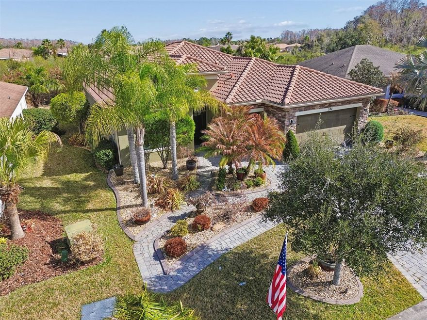 One or more photo(s) has been virtually staged. This exceptional custom 3-bedroom, 3-bath Cannes model offers a rare and highly desirable layout with two true primary bedroom suites, all perfectly positioned on a premium conservation lot in a quiet, private neighborhood just moments from the Palms Resort amenities center. From the moment you arrive, the home’s **custom landscaping—arguably the finest in the neighborhood—**and elegant stone façade create striking curb appeal and a warm, welcoming presence. Enter through the screened front entryway and elegant leaded glass front door into a bright, open-concept living space designed to maximize comfort and views. The main living area is enhanced by a solar tube that fills the space with natural light, while expansive windows frame serene conservation views, creating a peaceful indoor-outdoor connection. The chef’s delight gourmet kitchen is both beautiful and functional, featuring granite countertops, abundant custom cabinetry, a built-in oven and microwave, cooktop, and a spacious eat-at bar ideal for casual dining or entertaining. A charming breakfast nook overlooks the conservation area, while a dedicated formal dining room provides the perfect setting for hosting guests and special occasions. Both primary bedroom suites are thoughtfully designed as private retreats, each offering tranquil conservation views, two custom closets, and luxurious en-suite bathrooms with dual vanities. One suite features a walk-in shower, while the other boasts a relaxing garden tub, ideal for unwinding at the end of the day. Each primary suite is also equipped with a smart heated toilet/bidet, adding an extra touch of modern luxury and comfort. The guest bedroom is located separately from the primary suites, offering privacy for visitors, and is conveniently paired with a guest bathroom featuring a walk-in shower—perfect for overnight guests or extended stays. Designed for Florida living at its finest, the home features an impressive 662 sq. ft. covered and screened lanai, ideal for entertaining, relaxing, or simply enjoying the expansive conservation views in complete privacy. This outdoor space easily accommodates seating, dining, and lounging areas, making it an extension of the home’s living space. Additional highlights include a two-car garage plus a dedicated golf cart garage, all with durable epoxy flooring and ample storage space. Major upgrades provide peace of mind and added value, including a tile roof (2012), new HVAC system (2025), whole-house water filtration system, and double-pane windows for energy efficiency and comfort. This meticulously maintained, thoughtfully upgraded home combines luxury, privacy, and functionality in one of the community’s most desirable settings—a truly special property that must be seen to be fully appreciated. Solivita is a premier 55+ community, offering residents an exceptional lifestyle with state-of-the-art amenities. Enjoy a fully equipped fitness center, dance and aerobics studios, and an impressive array of recreational options including 14 heated swimming pools, two heated spas, tennis courts, pickleball courts, shuffleboard, bocce ball, billiards, and an art gallery. The community also features three on-site restaurants and two championship 18-hole golf courses. With a full calendar of activities and events, there’s always something new to explore and enjoy. This home is conveniently located near a hospital and medical office complex, and shopping center.