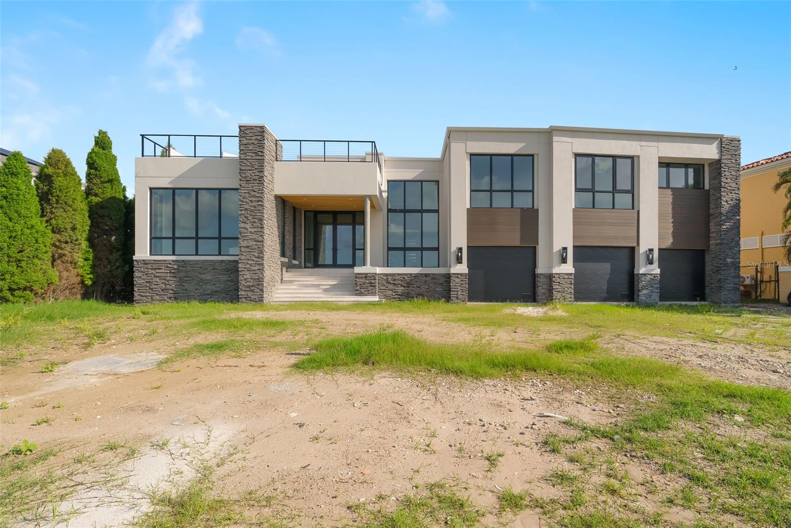 Under Construction. Under Construction. Open Bay views and unseen modern design on Davis Islands. This modern home is built for entertaining and ease of living by Forge Building Co. Enjoy spectacular open Bay views from much of the home with exceptional outdoor living spaces facing front and back. The home features 4 bedrooms, 5 and 2 half baths, one rooms is a semi detached guest suite, and office, along with two outdoor kitchens, one one the back outdoor living space and one on the rooftop deck. Spectacular modern kitchen with built-in Gaggenau fridge and freezer, Gaggenau cooktop, and three Gaggenau wall ovens. The club room is entered thru pivoting doors and is the ultimate entertaining space. It includes a full wet bar, ice maker, and two built-in subzero 146 bottle wine coolers as well as plenty of room for pool table and has a double sided fireplace. The guest retreat off the Lanai offers a semi-connected bedroom for guests or family to enjoy. A second story "roof top oasis" will offer an amazing and unique space to relax or entertain. The 50'x15' pavered deck will include an outdoor kitchen complete with grill and fridge. Just off the roof top oasis, the semi-private Study with sliding glass doors offers a quiet place to relax or get some work done while enjoying endless open bay views. a bedroom completes the area. Spacious Master bedroom and bath with stunning views as well as private wet bar, private elevator access, sitting room, and fireplace. Separate Media room with fridges and plenty of space for any buildout you desire. Back porch will include an outdoor kitchen and overlook a beautiful pool and spa. Some of the appointments of the home include an elevator, 4 car tandem garage, Impact resistant window walls, almost all 2 story block construction, quartz and marble countertops thru out, built-out closets, and much more! Located on beautiful Davis Islands just across from the walking and bike path and just a short distance away from Davis Islands Village with many restaurants, shops, and bars. Bring your golf cart and enjoy the Island lifestyle with walking / biking paths, baseball fields, public tennis courts, public historic pool, two dog parks (one wet and one dry), a beach, public marina, and an airport. Located only minutes from Downtown Tampa, Water Street, Sparkman Wharf, and the Tampa Riverwalk, makes this neighborhood the most desired in South Tampa!