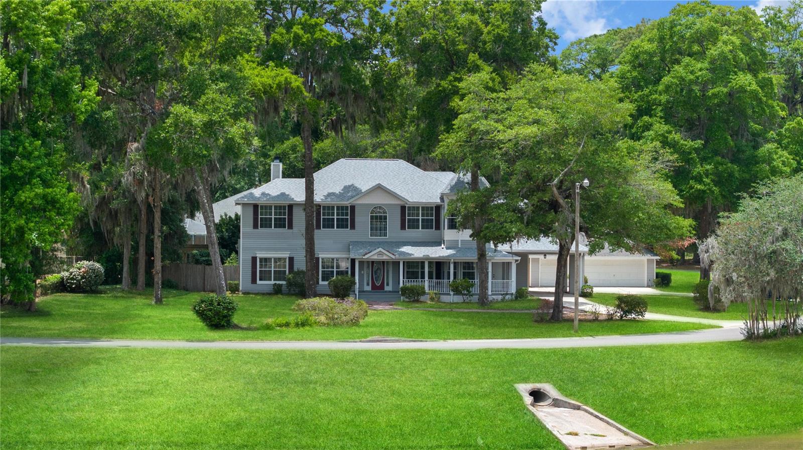 One or more photo(s) has been virtually staged. FOR SALE / LEASE OPTION / SHORT TERM RENTAL. Welcome to Your Dream Home! NO HOA. Nestled on over half an acre, this stunning modern Victorian home offers the perfect blend of timeless elegance and contemporary comfort. With 5 bedrooms and 4 full baths, this home is both an entertainer’s paradise and a haven for large families. Begin your day with a cup of coffee or unwind in the evening on the expansive wrap around porch, which overlooks a peaceful private pond—your own tranquil escape just steps from your door. Inside, the home has been fully remodeled, thoughtfully combining classic Victorian charm with modern amenities. Enjoy the luxury of two primary suites—one on the main floor and another upstairs—each offering ultimate privacy and comfort. The chef’s kitchen features abundant cabinetry and generous counter space, making meal prep effortless. For added convenience, there are laundry closets on both floors, eliminating the hassle of carrying laundry up and down stairs. Recent updates include a NEW- ROOF, HVAC, POOL PUMP, GARAGE DOOR MOTORS providing peace of mind and worry-free living for years to come. Step outside to enjoy a screened-in pool & a fully detached 3-car garage with ample storage and parking & a spacious driveway easily accommodates additional vehicles. This extraordinary property seamlessly fuses the grace of Victorian architecture with the functionality and ease of modern living. Don’t miss the opportunity to make this one-of-a-kind home your own. Call today. ALSO LISTED FOR SALE. MLS OM702503. SHORT OR LONG TERM RENTAL. OWNER WILL FURNISH HOME FOR $7,500 - MINIMUM FOUR MONTHS. PETS OK WITH DEPOSIT.