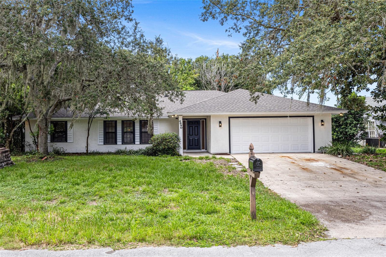 A completely remodeled gem in Titusville – step inside and fall in love!
Welcome through the elegant foyer into a formal living room that feels both inviting and refined. This home features a thoughtful split floor plan with 4 bedrooms and 2 full bathrooms, including a luxurious ensuite in the primary suite. Explore your dream kitchen: stunning quartz countertops, a sleek waterfall-edge island with light pendants, 42" ceiling-height soft closing cabinets, built-in oven and microwave, cooktop with hood, and stainless steel fridge and dishwasher. The kitchen effortlessly flows into an airy family room, where vaulted ceilings, decorative wood beams, and skylights bathe the space in natural light, all centered around a cozy wood-burning fireplace. To the other side, a spacious dining area awaits your gatherings. Out back, a beautiful climatized Florida room full of windows allows access to a brick-paver patio, a lush green backyard, and a brand-new gazebo—perfect for relaxing, entertaining and watch rocket launchings! Additional features include a laundry room with sink and abundant cabinetry, a two-car garage with new garage door motor, and a large workshop-style storage room in the back, complete with water connection and electricity. Nestled on a quiet cul-de-sac, this home also comes with a brand-new roof, AC and water heater. Welcome to your home sweet home!