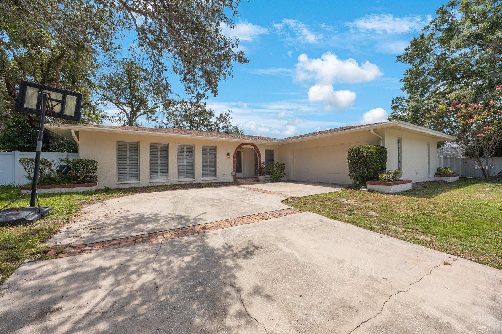 Location! Location! Location! This spacious pool home is located in desirable Sharon Oaks community! Some special notes: 4 bedrooms, 3 full baths, massive laundry room, Primary bedroom with ensuite bath with jetted tub and separate shower to name a few! The bird caged pool with covered lanai is a perfect spot for relaxing and entertaining! This home has 2 large living areas and a split plan layout! The lot is enormous with plenty of room for play and gardening outside the pool enclosure! This home did not suffer any flood water intrusions during the storms of the century last year! While this home can use some updates and finishing touches the roof was just replaced and there are solar panels (fully paid for) that make the electric bills low and affordable! Close to Parks, Rec Center, shopping, restaurants, and the new downtown Largo area coming soon! Priced below many homes in the area so do not miss this opportunity to make this spacious pool home your own! Location/Layout/price are all a win!!! Paradise found!!