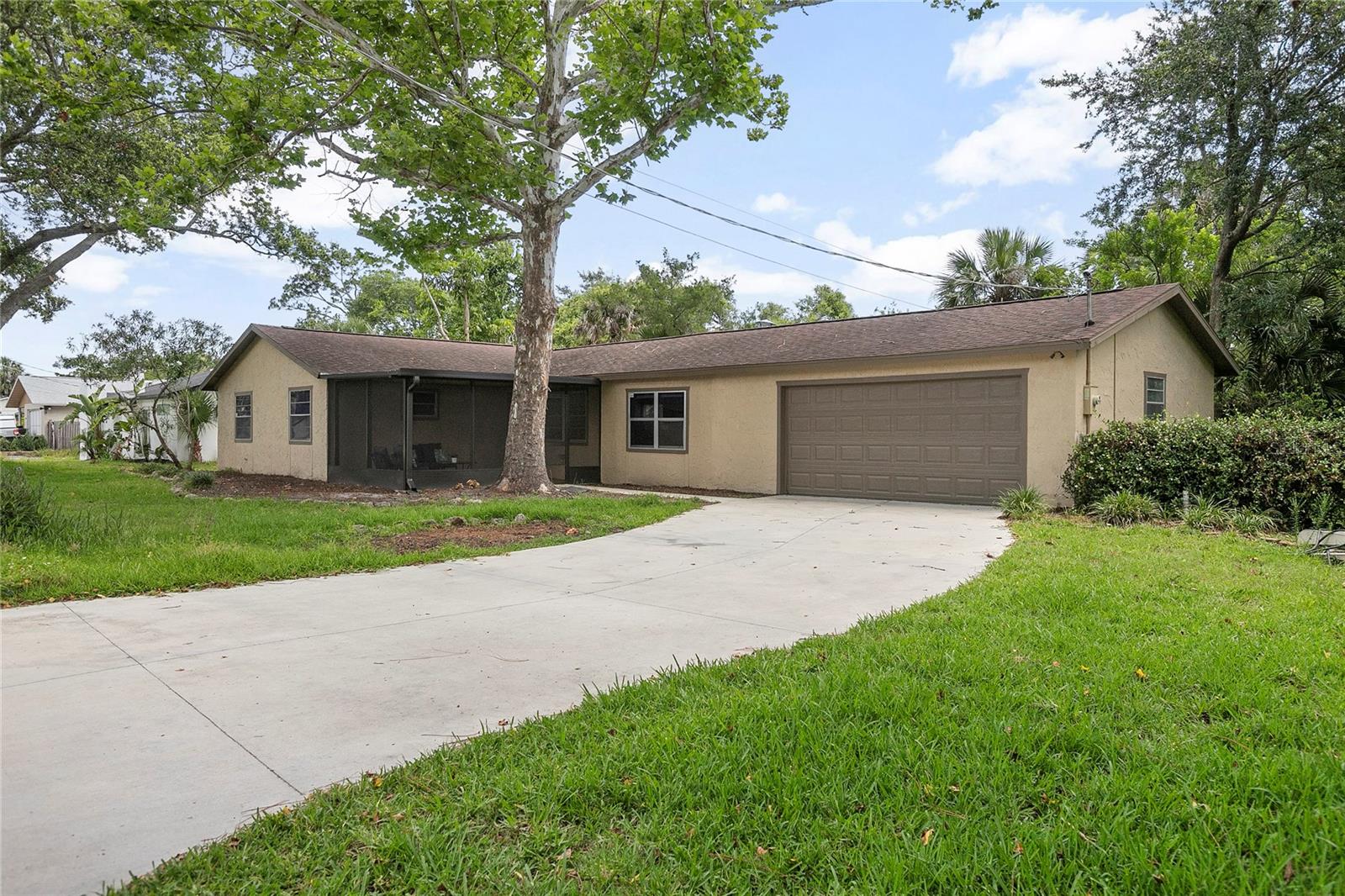 Welcome to this beautifully remodeled three-bedroom, two-bath home in the heart of Port Orange, ideally on an oversized lot spanning more than half an acre. Just minutes from the Intracoastal Waterway, beaches, U.S. 1, shopping, restaurants, and the iconic Sunglow Pier, this home offers convenience and a laid-back coastal lifestyle. Go inside through the screened-in front porch and be greeted by an open-concept living space, seamlessly connecting the living room, kitchen and dining area. The new kitchen features soft-close cabinetry, granite countertops, recessed lighting, and a center island perfect for gathering. All appliances will be installed prior to closing. Luxury vinyl plank flooring runs throughout the home, complemented by fresh paint, new texture and updated baseboards. The primary suite offers dual built-in closets and a stunning en-suite bath with a glass-enclosed, newly tiled shower. Two additional bedrooms share a fully updated guest bath featuring new tile work and a granite vanity top. The air conditioning unit was replaced in 2022, offering added peace of mind and energy efficiency. Outside, enjoy the expansive, fenced-in side yard and a spacious wood deck—ideal for entertaining, barbecues or relaxing under the stars. With a two-car garage, no HOA and a location that puts the best of Port Orange within easy reach. Set on a generous-sized lot, this property offers exciting potential — whether you're looking to build a second home, add a detached garage or workshop for your toys and tools, or simply enjoy the extra space for outdoor entertaining, gardening or future expansion. Opportunities like this don’t come around often!