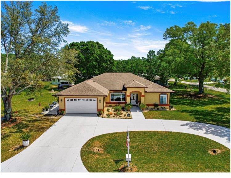 Step into a beautifully cared-for 3-bedroom, 2-bathroom sanctuary offering over 2,100 square feet of warm, inviting living space. Nestled on an expansive nearly half-acre corner lot, this home feels like your own private park, surrounded by lush, colorful landscaping nurtured by its very own irrigation well. From the moment you arrive, you’ll sense the peace and security of a community that’s not just growing, but thriving. This home has been thoughtfully updated with your comfort and future in mind: the roof was replaced in 2017, the HVAC system is a reliable newer model from 2010, and the Florida room boasts brand new windows installed in 2023. A new hot water heater rounds out these key updates, ensuring you move in with peace of mind and minimal worry. It’s more than a house — it’s a smart investment in quality and longevity. Inside, a stunning 13 by 29 enclosed Florida room beckons with walls of windows that flood the space with natural light. Imagine cozy evenings by the indoor bar and grill, or lively gatherings with friends and family spilling into the backyard. The chef’s kitchen invites you to create with generous cabinets, ample prep space, and a breakfast bar accented by charming pendant lighting — all flowing seamlessly into the open dining and living areas. Soaring 10-foot ceilings and a cozy sitting room with a wall-mounted electric fireplace create an ambiance that is both grand and welcoming. The primary suite is a true retreat, featuring dual walk-in closets, his and hers vanities, an enclosed tiled shower, and a relaxing garden tub. Two additional guest bedrooms and a well-placed guest bath add comfort and privacy for family or visitors. A large laundry room equipped with washer, dryer, abundant cabinetry, countertops, and a utility sink adds to the everyday convenience. Living here means becoming part of Cherrywood Estates, a community rich with amenities designed for relaxation and connection: enjoy trash removal, Spectrum TV and WiFi, a clubhouse buzzing with events, a resort-style pool and hot tub, and a covered pavilion perfect for any celebration. All this just minutes from shopping, professional offices, and restaurants. Everything you need is right at your doorstep. This home is wired for ADT security and features a Nutone intercom system throughout, providing an added layer of comfort and safety. Whether you’re entertaining guests, nurturing creative passions, or welcoming extended family, this home adapts effortlessly to your lifestyle. Don’t miss the chance to make this haven your own—a rare blend of peace, community, and smart upgrades in a growing, vibrant area. The time to act is now. Book your showing today!