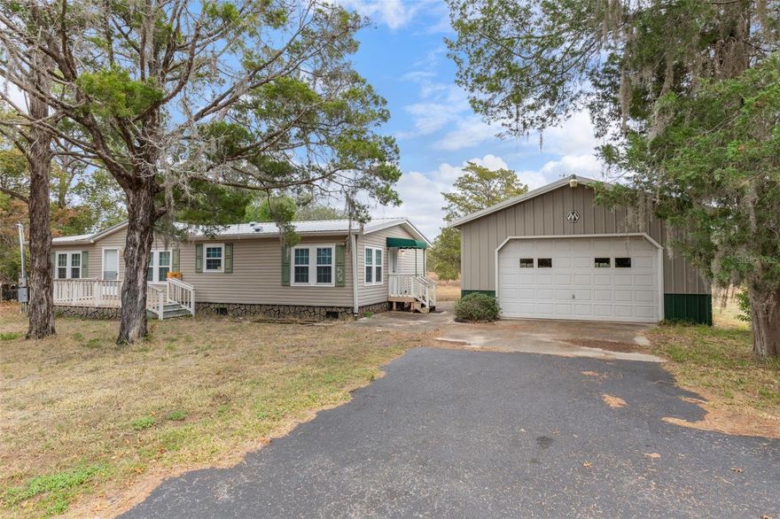 Escape to your own serene Homosassa hideaway!  Tucked back on 4.77 acres two separate Alt key numbers:1516978 is 2.37 acres and alt key # 1516960 is 2.40 acres, this charming 2-bedroom, 2 bathroom double wide mobile home offers the peaceful rural lifestyle you've been dreaming of.  The home features a durable metal roof, a welcoming front deck, and a screened back porch an outstanding choice for your morning coffee or winding down at sunset.  A huge 24 x 38 detached garage gives you endless possibilities-cars, toys, tools, workshop, hobby space, or storage galore.  These two parcels are being sold together as one property, you'll have all the elbow room you could want.  Located near Cardinal Street with super easy access to the Suncoast Parkway, this property gives you both convenience and serenity.  Bring your animals, bring your projects-there's space for everything. A metal gated entrance and wood fencing complete this perfect country package.
