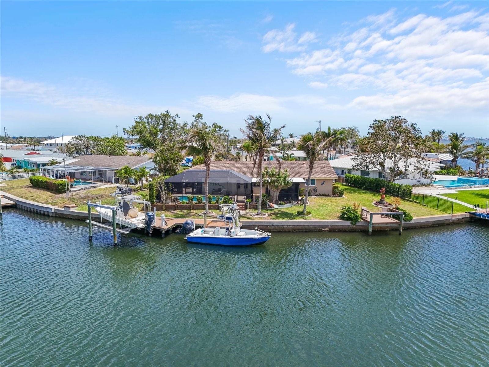 NEVER FLOODED! Welcome to 10432 Sandpiper Road W, a stunningly maintained coastal home in the highly desirable Flamingo Cay community—just minutes from the powdery beaches of Anna Maria Island. Offering direct Gulf access and nestled along a peaceful canal, this waterfront gem is perfect for boating enthusiasts and anyone craving the ultimate Florida lifestyle.
Enjoy peace of mind and superior protection with hurricane-impact windows and doors and a proven flood-free history—a rare find in waterfront living. This home has been thoughtfully updated to reflect relaxed luxury, coastal charm, and modern convenience.
Step inside and feel instantly at ease in the light-filled open floor plan. The newly opened-up kitchen layout flows effortlessly into the living and dining areas, creating the ideal space for entertaining or quiet relaxation. The kitchen features granite countertops, stainless steel appliances, and abundant cabinetry—all beautifully complemented by durable, easy-to-maintain tile flooring throughout the main living spaces.
The home has been freshly painted inside and out, giving it a bright, clean, and welcoming feel. Newer carpets add comfort in key areas, and tasteful finishes throughout give this home a polished, move-in-ready appeal.
Step outside to your own private backyard oasis, where a screened lanai opens to a sparkling in-ground pool surrounded by lush tropical landscaping. The private dock offers two boat slips—one equipped with a boat lift. Whether you're heading out for a morning cruise, an afternoon of fishing, or a sunset sail, this location makes it effortless.
Flamingo Cay is known for its relaxed coastal vibe and unbeatable proximity to local treasures like Robinson Preserve, Palma Sola Bay, and the dining, shopping, and cultural experiences of downtown Bradenton. And with Anna Maria Island’s beaches just moments away, you're perfectly positioned to enjoy all the best that the Suncoast.
Whether you're searching for a full-time residence, a seasonal escape, or a waterfront investment, this home offers the rare combination of location, lifestyle, and lasting value.