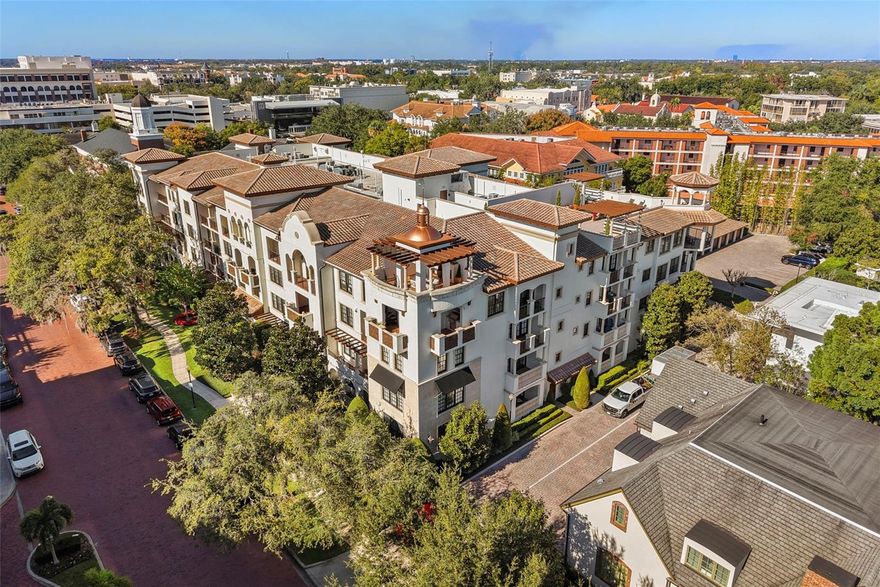 Located on the second floor of Villa Siena, this two-bedroom, two-bath residence offers 1,511 square feet of elegantly appointed living space with two balconies overlooking New England Avenue’s tree-lined brick streets in the heart of Winter Park. A split-bedroom layout ensures privacy, with wood flooring and tray ceilings defining the open-concept living and dining areas. The kitchen features solid wood cabinetry, granite countertops, a Sub-Zero refrigerator, and Wolf gas cooktop and oven. Both bedrooms include walk-in closets, tray ceilings, and direct access to private balconies via French doors. The primary bath is designed with dual vanities, a deep soaking tub, and a walk-in shower finished in natural stone. Travertine flooring continues through the entry, kitchen, and baths, while the full laundry room includes built-in cabinetry and utility closet storage. This residence includes one assigned space in the secured below-ground garage, and an additional ground-level garage space. Villa Siena amenities include a fitness center, rooftop terrace, club room with bar and outdoor seating, conference room, guest parking, and on-site management. Enjoy direct access to Park Avenue’s boutique shopping, dining, museums, and Central Park, with the Alfond Inn’s restaurant, café, and lounge just across the street.