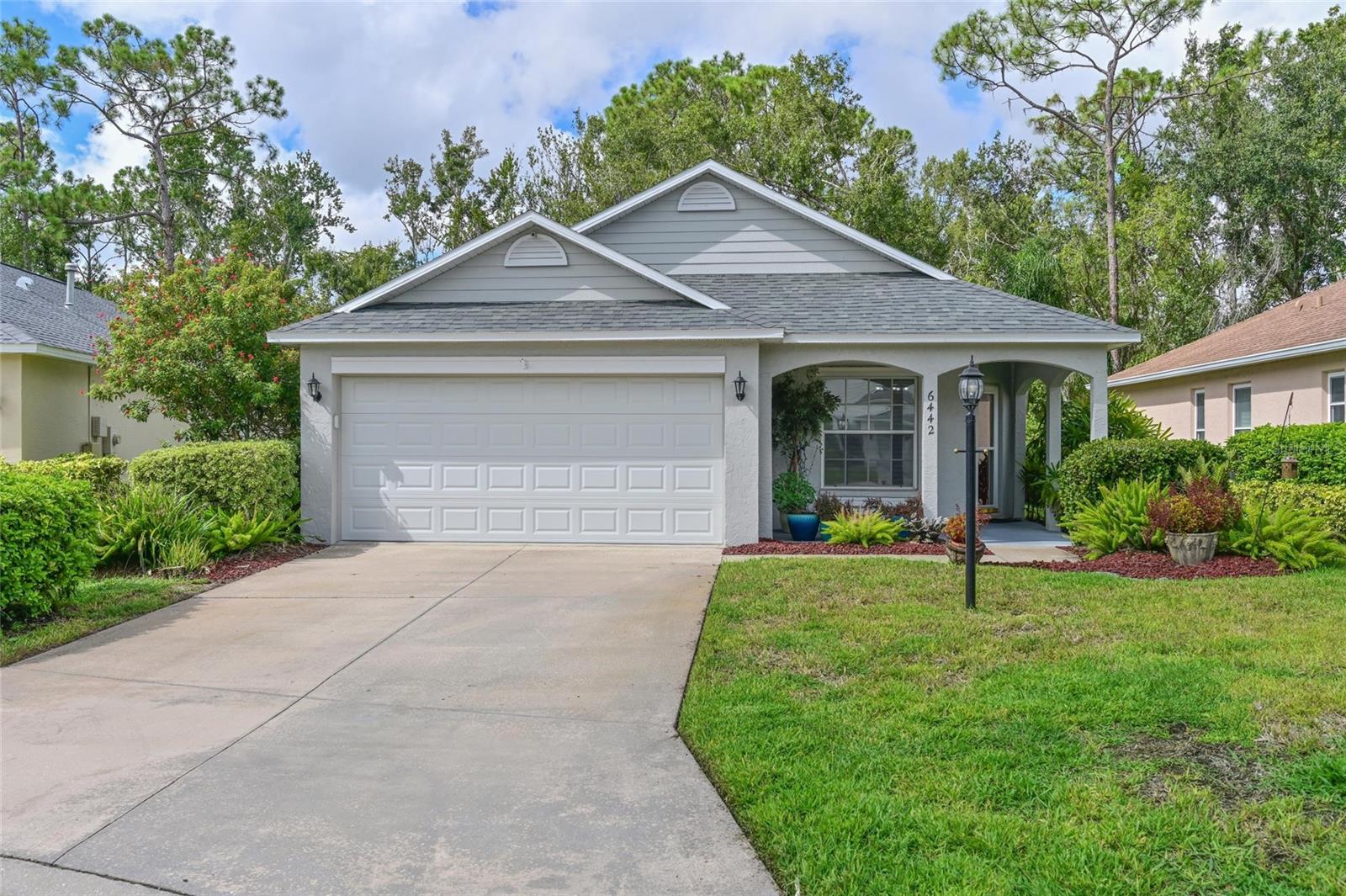 Charming Home situated on a Private Preserve Lot in a Maintenance-Free Community. The welcoming covered front porch is the perfect place to relax, offering inviting curb appeal and creating a warm first impression. Tucked away on a serene, cul-de-sac lot, this well maintained 2-bedroom, 2-bath home offers 1,638 sq. ft. of thoughtfully designed living space. High ceilings and a well-planned layout create an open, airy feel throughout. The formal living and dining rooms welcome you inside, leading to a spacious family room that flows seamlessly into the kitchen and outdoor living area. The fully equipped kitchen features quartz countertops, pull-out shelving, a gas range, double pantries, and new tile flooring—perfect for both everyday living and entertaining. Step outside to the covered, screened lanai and take in the tranquil preserve view. The primary suite boasts dual sinks with quartz counters, a walk-in shower with seamless glass doors, and a linen closet. The second bedroom offers excellent privacy for family or guests with its own bath access, framed mirror, quartz counters, linen closet, and a large walk-in closet. Recent major updates include new roof (Aug 2025), AC (2024), Water Heater (2025), Interior Paint (2025), and New Garage Door (2021). Additional features include a garage sink, EV charging outlet, Hurricane shutters, security system, humidistat control on the thermostat, and an extended 2-car garage. Located in the heart of Lakewood Ranch, you’re just minutes from downtown Lakewood Ranch, UTC Mall and Waterside Place, offering endless dining, entertainment, and community events—all within a top-rated school district. Enjoy the fabulous amenities of Summerfield Village, including a community pool and nearby Summerfield Park with three playgrounds, tennis courts, a basketball court, baseball and soccer fields, jogging paths, and a covered pavilion—all set within a beautiful 15-acre park.