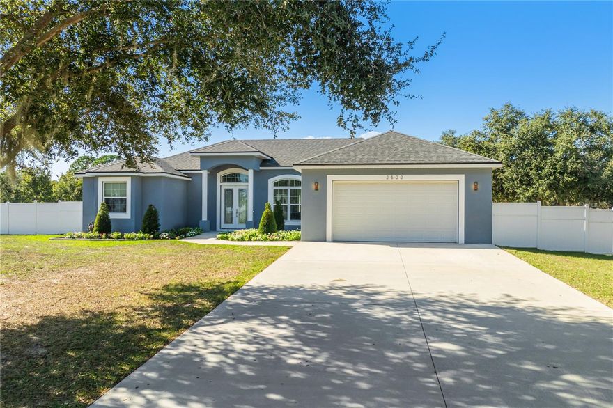 Custom-built and thoughtfully designed, this one-acre corner-lot residence offers a rare sense of space, privacy, and calm within a peaceful lakefront community with lake access and an optional HOA of just $150 yearly. Created for an owner who valued quality, comfort, and quiet living, the home feels intentional, refined, and welcoming from the moment you arrive.

Vaulted ceilings and 33x33 porcelain tile flooring throughout create an open, sun-filled interior with a seamless flow. The kitchen serves as the heart of the home, featuring quartz countertops, LG stainless steel appliances, and a layout ideal for everyday living and relaxed entertaining.

Each bedroom features custom-built closets, while the primary suite offers spacious walk-in closets that balance elegance and functionality.

Step outside to an expansive backyard that feels like a private retreat, complete with  avocado and mango trees and ample space to relax, gather, or enjoy the quiet surroundings. The corner-lot setting enhances privacy and flexibility.

This home is designed to slow life down—where refined finishes, generous land, and a tranquil, lake-oriented setting come together effortlessly.