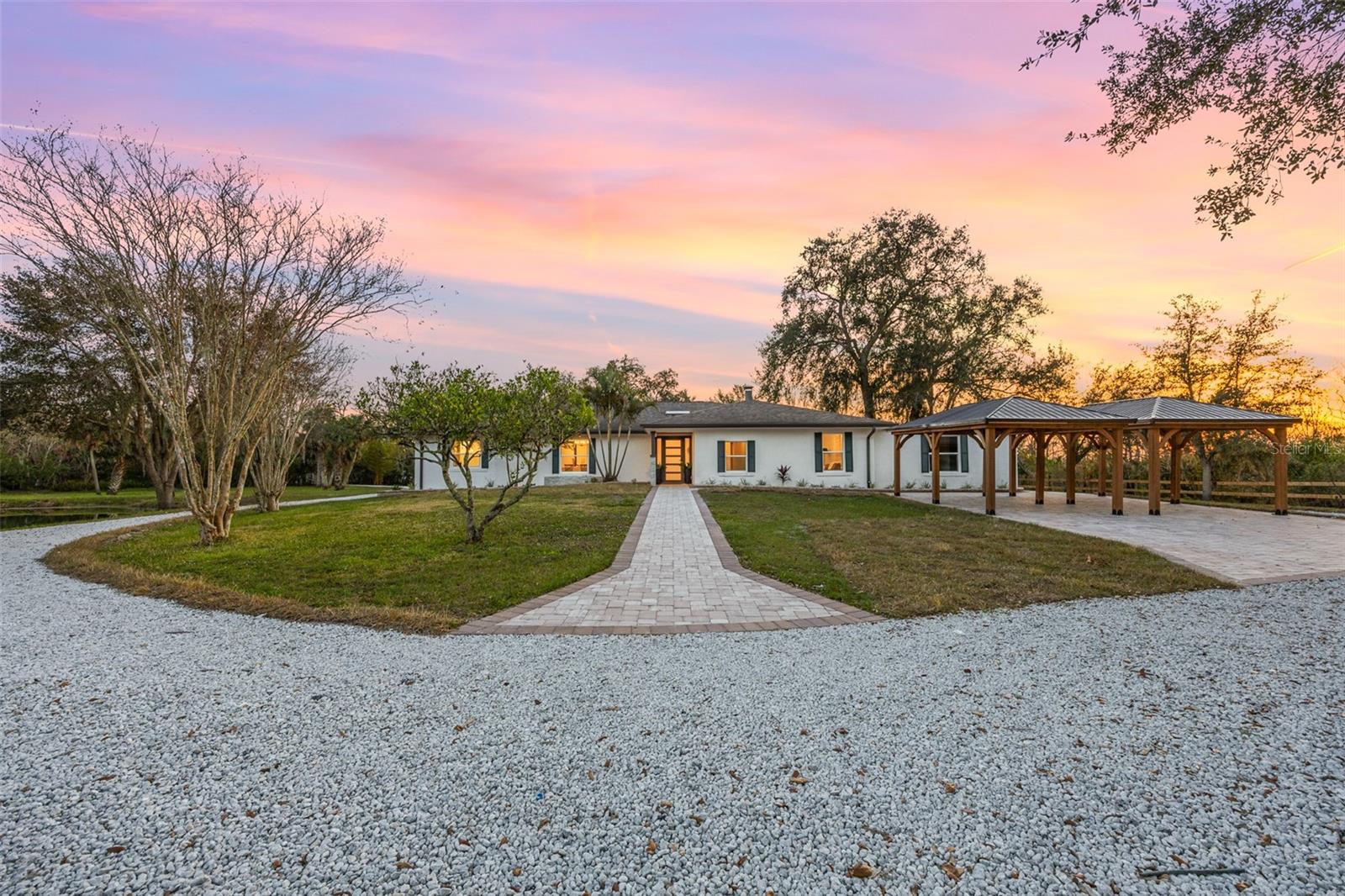 Absolute Serenity. 4.82 Acres of flat, open and fenced-in land in Windover Farms. The property backs up onto protected conservation land-ensuring no future developments behind the home and total privacy all the way around this ideally shaped lot. Inside the home, organic and modern updated finishes complement this open-concept floorplan that is perfect for entertaining. Outdoor living with a fully custom summer kitchen and paved pool area. Featuring 5 bedrooms, 3 full bathrooms, and a generous in-law suite with its own exterior entrance, AC and nook - ideal for quests or extended family. The front of the property features two full-size carports that can cover nearly any vehicle and a wraparound paved driveway. 2018 Roof, 2022 Electrical Panel, 2024 Tankless Water Heater, and all brand-new Café appliances with 3 year warranties.