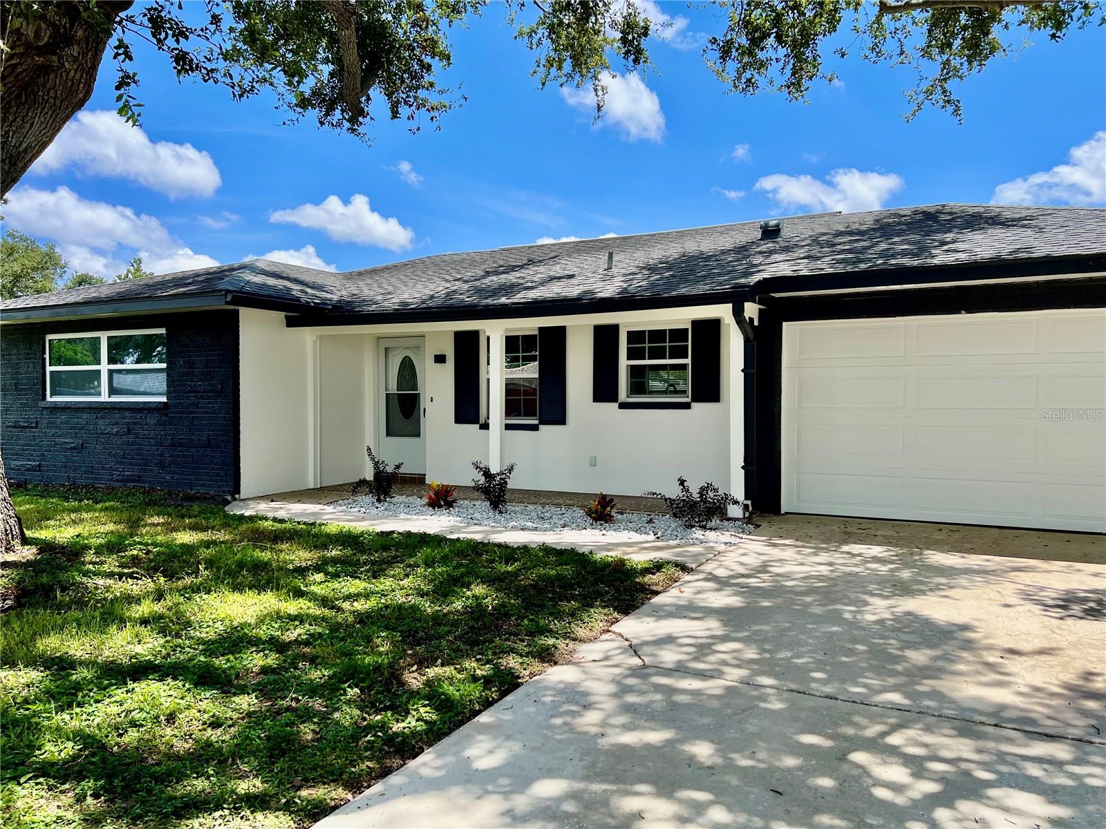 One or more photo(s) has been virtually staged. Completely Renovated & Move-In Ready!?
Welcome to this beautifully updated 3-bedroom, 2-bath single-family home in a desirable, quiet neighborhood—no flood zone and no HOA fees! Every inch of this property has been thoughtfully modernized for style, comfort, and efficiency. Step into a bright, open-concept kitchen featuring ample crisp white cabinetry complete with a lazy susan and pull-out spice rack, soft close drawers, a spacious island, gleaming stainless steel appliances, quartz countertops, a deep under-mounted sink, quartz backsplash and two large windows that fill the space with natural light. The kitchen flows seamlessly into the living areas, all accented by brand-new, wood-look luxury vinyl flooring throughout. The primary suite offers a walk-in closet and a stunning en suite bath with a glass-enclosed shower, stainless diverter valve for wand, spray and rain shower head, quartz countertop, ample drawers and storage with ceramic flooring. Large hallway linen closet plus a coat/utility closet provide excellent storage options. Double pane argon-filled Energy Star windows throughout, fresh interior and exterior paint, and all-new lighting—including recessed kitchen lighting—add to the home’s appeal. Enjoy Florida living in the fully fenced backyard with a deck, built-in flower gardens, a patio with retractable awning, and an automatic sprinkler system. The attached 2-car garage offers attic storage. With brand-new ceiling fans in every room, upgraded fixtures, and a fresh modern look, this home is the perfect blend of charm and contemporary style. Move right in and start enjoying your new home today! Qualified buyers may receive a 1-year interest rate buydown for the first year paid for by the Seller's preferred lender when financing this home (subject to credit approval and program availability) - call today for details.