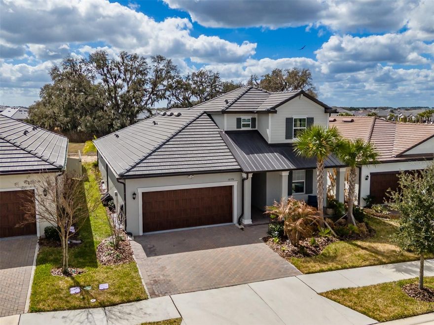 Serene pond setting, 3-bedroom, 3 full bath, 2366 sq ft, 2023 built 2 story Meridian II model located in the 55+ Medley At Mirada community, offers an open concept kitchen, dining room and Family room that overlooks the screened Lanai and pond. Quartz countertops are throughout. The owner’s suite is located on the first floor, with an ensuite bathroom featuring double sinks with a  private water closet, shower, and a large walk-in closet. The second bedroom, Flex room and Full Bathroom are also on the Ceramic Plank Tiled first floor along with a 3-car tandem garage with over 200 sq. ft. overhead storage. The second floor boasts a large, carpeted loft area and third bedroom and bathroom. The perfect place for family and friends to stay while visiting. All bedrooms, loft, Family room, Flex room, and Lanai  have ceiling fans. High speed fiber optic internet (ULTRAFI) & Spectrum cable TV is included in the HOA fee. Residents of Medley At Mirada have access to the resort style heated pool and amenity center equipped with café & bar, billiards room, card room, ballroom, 24 hr. fitness center, Sports courts featuring, tennis, pickleball, shuffleboard & bocce ball along with a tot lot and a dog park. There are many clubs, activities, and events for fun and enjoyment. In the heart of Mirada is the 15-acre Crystal Lagoon. The largest man-made Lagoon in the nation. Enjoy the crystal-clear blue water with a swim up bar, sandy beaches, cabanas, water slide, water splash zone, kayaking, water obstacle course. The Lagoon offers numerous activities  and entertainment for year-round enjoyment. This golf cart inspired community has a Publix shopping center at its entrance and is near Dade City, The Shops at Wiregrass and Tampa Premium outlet malls, The Grove, Golf courses, Bay Care and Advent Hospitals, with close proximity and easy access to Interstate 75.   CDD IS ALREADY INCLUDED IN TAX AMOUNT