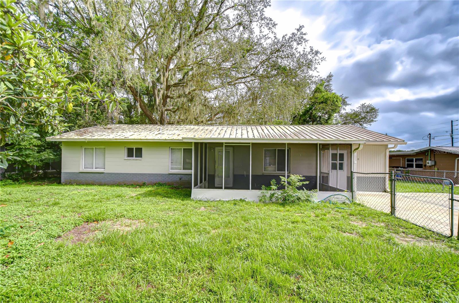 Charming 3-Bedroom Block Home in West Zephyrhills – No HOA! This well-maintained single-family block home is full of potential—whether you're looking for a great starter home, a comfortable place to retire, or a smart investment opportunity. Situated on a generous .24-acre lot with no HOA, this property gives you the freedom and flexibility to make it your own. Inside, you’ll find tile flooring throughout, offering easy maintenance and a clean, modern feel. The spacious indoor laundry room adds convenience, and the thoughtful layout provides functional living space filled with natural light. The fenced front yard offers added privacy and room for pets or play, while the metal roof brings peace of mind with its durability and low maintenance. This home features not 1 but 2 screened porches, With no HOA, you're free to add your personal touches or explore rental possibilities. Located on the west side of Zephyrhills, just a short distance from Zephyr Park, shopping, dining, and local attractions, this home is ideally positioned for both homeowners and potential tenants alike. Whether you're ready to settle in or searching for a great income-producing property, this is a fantastic opportunity you don’t want to miss!