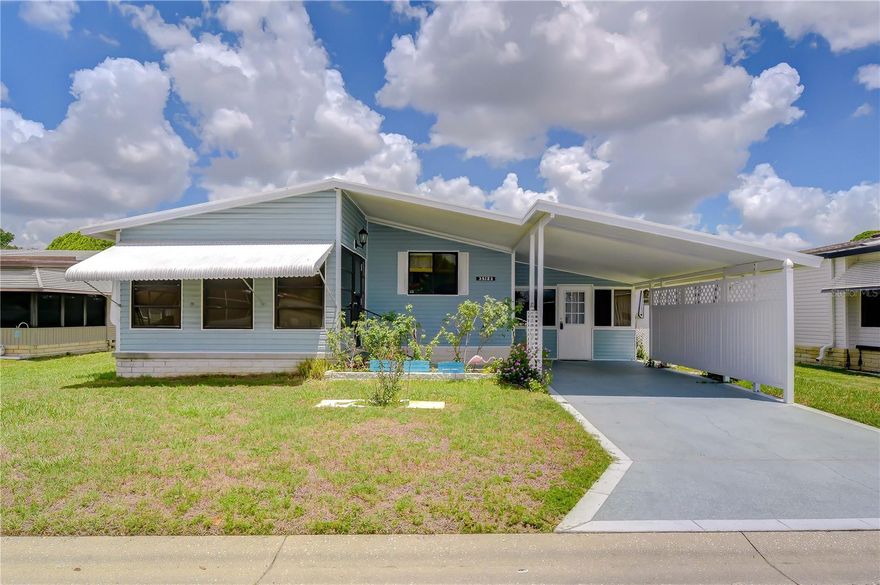 Welcome to Colony Hills, a vibrant 55+ community where you own the land — no lot rent! Whether you are searching for a winter retreat from the cold north or a full-time Florida residence, this home offers space, versatility, and comfort. The front of the home features a covered carport along with a covered open porch, perfect for relaxing outdoors or entertaining guests. Entering from the carport, you are welcomed into a spacious 22’ x 11.75’ bonus room complete with ceramic tile flooring, glass windows and AC, offering endless possibilities like a family room, game room, craft studio, Florida room, or hobby space. This area leads to the laundry room and an additional storage room for added convenience. Inside the home, the dining room is open to the kitchen and features beautiful wood flooring along with built-in cabinetry to display your favorite dishes and collectibles. The kitchen offers ample cabinetry, abundant counter space, a breakfast bar, nice appliances, and wood flooring. Flowing from the dining room is the spacious living room, approximately 15’ x 13’, with a slider leading to an additional 13’ x 10’ flex room with AC & ceramic tile flooring ideal for a den, exercise room, office, or hobby area. The primary bedroom is located at the back of the home and has a large closet which includes an en-suite bathroom with shower, and linen closet. The second bedroom offers ample closet space and is conveniently located near the hall bathroom with tub/shower combination. In the back of the home is concrete patio ideal for grilling.  Enjoy all the amenities Colony Hills has to offer, including a large clubhouse, community pool, tennis courts, shuffleboard, and a variety of community activities and social events. Schedule your private tour today.