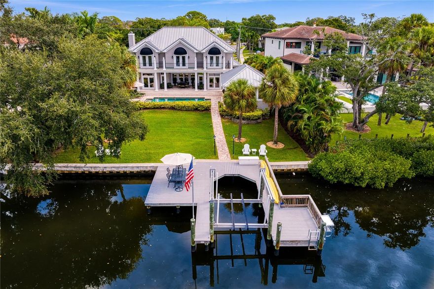 This Best Priced Waterfront Gem can be yours in this New Year! Welcome home to this exceptionally constructed custom waterfront home on a beautiful, serene canal leading to Old Tampa Bay. This lovely home is situated on an oversized homesite just shy of .5 acre and enjoys approximately 93’ on the water. Architecturally, the home has an Islands vibe with tabby stucco exterior with a standing seam metal roof and has 2 separate structures; the main home with 4 bedrooms/4.5 bathrooms, and a full detached guest house offering 529 sq. feet, equipped with a full generator and hurricane shutters. The open floor plan lends itself to magnificent flow for entertaining and connects easily to the beautiful covered outdoor dining area, the recently rebuilt pool and rebuilt dock, 10,000 lb. lift, with new plumbing and electric complete with a newer seawall cap. Many lovely improvements have been incorporated into the home including an updated Chef’s kitchen with loads of cabinetry and quartz countertops; Subzero and Thermador appliances; 3 newer water heaters (2016/2018), 4 air conditioning units (2017); solar panels for energy efficiency; new stone paver circular drive, front steps, Sonos speakers, wood floors throughout; and each of the bathrooms in the main home have been modernized. You’ll find an abundance of storage throughout the home with excellent well- organized closets; a butler’s pantry and an oversized walk-in pantry – plus two separate 2-car garages to house multiple vehicles. To live in this home is truly a “Sitting on the Dock of the Bay” moment, as you unwind in the evening catching the sunset or the occasional dolphin visitor. The home has been meticulously maintained and has benefited from many recent improvements and is ready for the next owner to take pleasure in this truly beautiful home and location. Hurry . . . . . this won’t last long!