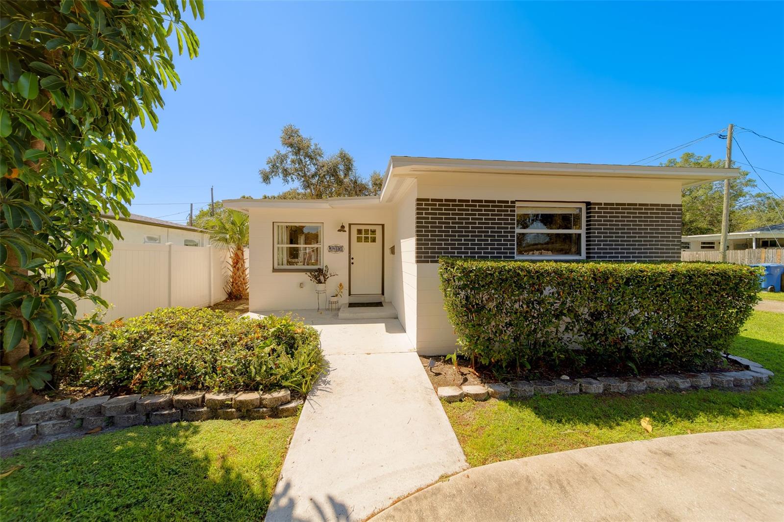 Welcome to this beautifully updated 3-bedroom, 1.5-bathroom home located on a prime corner lot in the heart of Central St. Petersburg. Offering a perfect blend of modern comfort and classic charm, this residence is designed to impress with its light-filled open concept and thoughtful upgrades throughout. The heart of the home is its stunning kitchen, featuring high-end LG stainless steel appliances—including a gas range—solid surface countertops, and plenty of cabinetry for all your culinary needs. The adjacent living and dining areas flow seamlessly, creating an inviting space perfect for both everyday living and entertaining. The updated full bathroom is a true standout, with elegant finishes that complement the home's modern aesthetic. You'll also appreciate the convenience of an inside laundry room complete with washer and dryer. The spacious rear sunroom, accessed through beautiful French doors, is the ideal place to relax while overlooking the gorgeous fenced backyard. Step outside to your private outdoor oasis, complete with a patio, lush grassy area, and a handy storage shed—all fully enclosed for privacy and security. The home is meticulously maintained, with a new roof installed in 2023, and features beautiful flooring throughout along with ceiling fans in every room for added comfort. There's also plenty of parking with a front circular driveway and a side entrance 2-car carport. Located just minutes from Downtown St. Petersburg, you'll enjoy easy access to shopping, dining, and vibrant nightlife, all while being nestled in a quiet, sought-after neighborhood. With so many desirable features, this pride-of-ownership home won't last long—schedule your showing today!