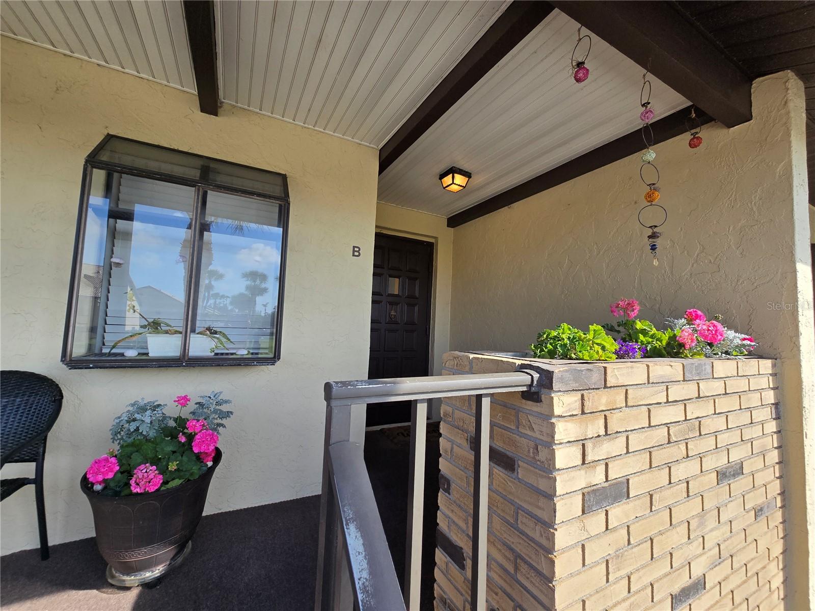 This spacious 2nd-floor end-unit condo offers a perfect blend of modern style and comfort. Recently remodeled, it features a top-of-the-line kitchen with granite countertops, sleek white cabinets, and newer white appliances. The open living area includes a dry bar, extending from the kitchen and boasts grey vinyl wood plank flooring throughout the entire unit, paired with fresh light grey paint for a contemporary feel. Large sliding doors in the living room allow abundant natural light to fill the space, making it bright and airy. The primary bedroom is generously sized and leads out to a private screened porch. The en suite primary bathroom features a double vanity, ample closet space, and a walk-in shower. Additional features include a stackable washer/dryer inside the unit, and the HOA provides access to three swimming pools, included with the property is water, sewer, trash, and basic cable. Enjoy the convenience of a carport with parking and extra storage space underneath. Please note that no pets are allowed, unless they are service animals. A rental application with the HOA is required for approval prior to moving in.