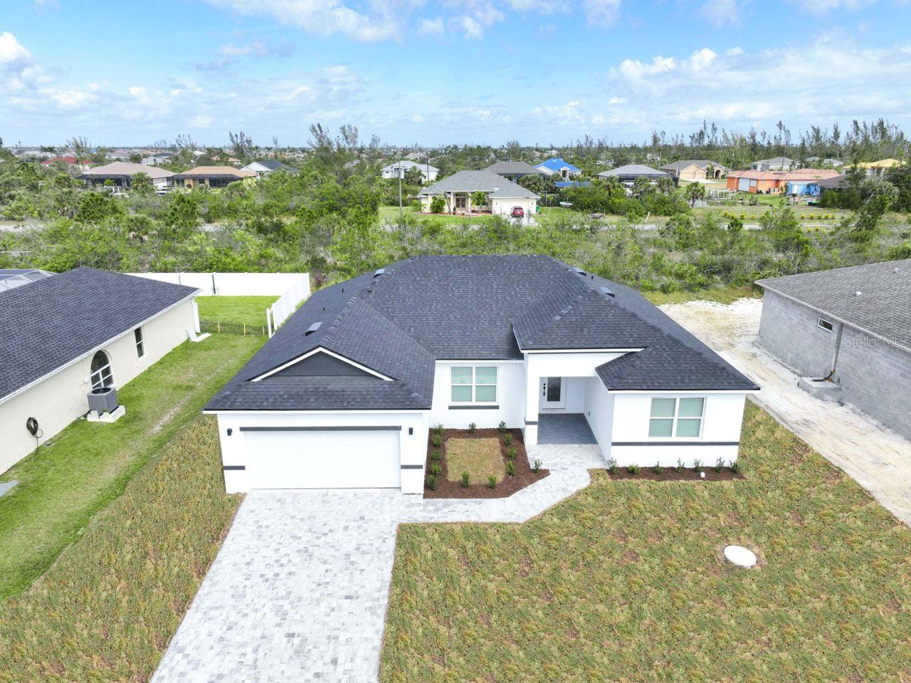 NEW CONSTRUCTION ready for immediate occupancy! Located in the waterfront community of South Gulf Cove, this new home has all the extras you have been looking for, including granite countertops, stainless steel appliances, white shaker kitchen cabinets with 42" uppers, fully tiled shower and tub surrounds, and super-durable luxury vinyl plank flooring throughout. The outside features an upgraded brick paver service walk and driveway, as well as a new fully sodded yard. Smart energy-saving features like high-efficient hot water heaters and mechanicals, Low-E windows, and low-flow fixtures will keep electricity bills low. The spacious open floor plan allows ample space for entertaining with an open concept Kitchen/Great Room and multiple dining areas including a breezy covered lanai.