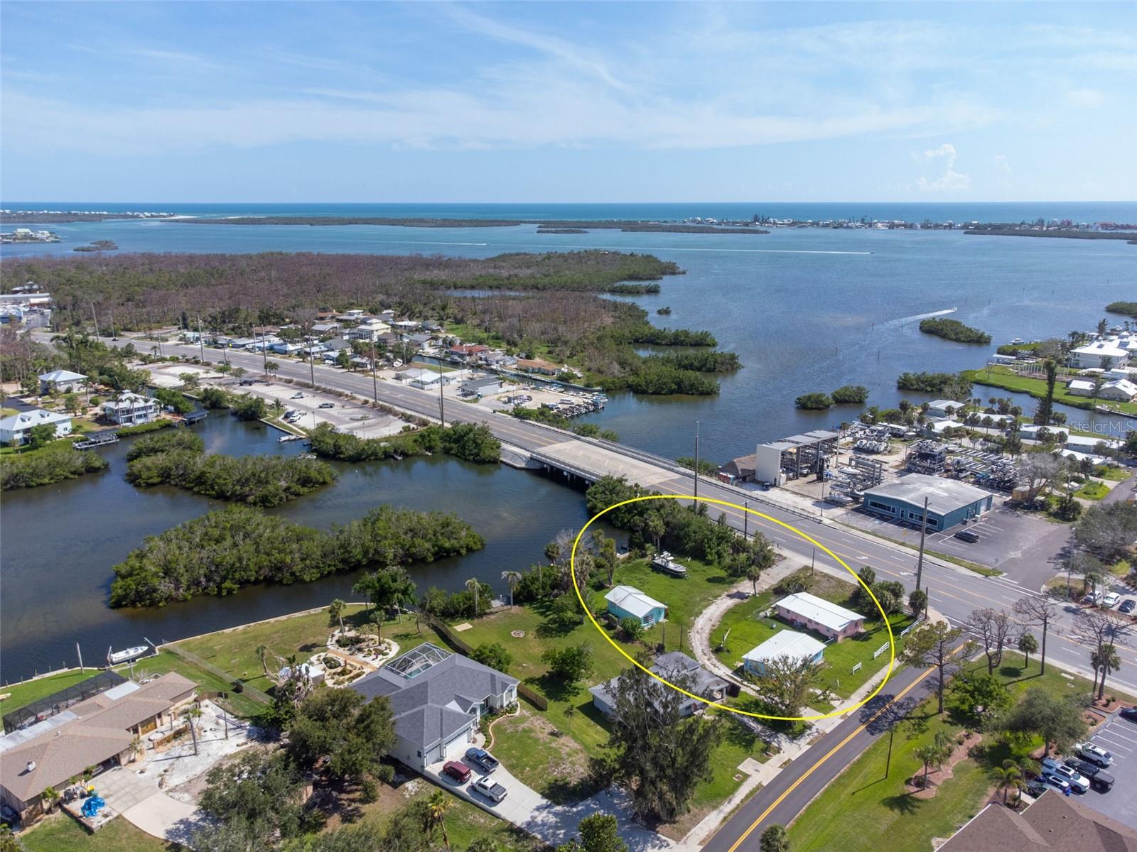 This exceptional property, located in the heart of Englewood, presents a truly rare and exciting opportunity to create your ideal WATERFRONT haven or a thriving multi-use development. While it sustained damage from recent hurricanes, this simply clears the path for endless potential in renovation or a complete rebuild. This expansive 0.72-acre lot, boasting an almost unheard-of 140 feet of direct water frontage. The property currently features three small homes, two at 1,008 square feet (2 beds/1 bath) and a third at 600 square feet (1 bed/1 bath), offering a starting point for your vision. With OMI (Office, Medical, Institutional) zoning, this isn't just a residential opportunity; it's a chance to develop a unique space that serves a variety of needs. Enjoy seamless boat access with a concrete seawall and a wood dock, and just one bridge leading you to the beautiful Intracoastal Waterway. A new metal roof was installed in 2019, providing a solid foundation for your rebuilding efforts. Located in flood zone AE, the property offers excellent accessibility with two separate entrances, one on Manor Road and the other on Placida, ensuring convenience for you or your future guests. Whether you envision a luxurious private estate or a dynamic investment venture, this property provides the canvas for your grandest designs.